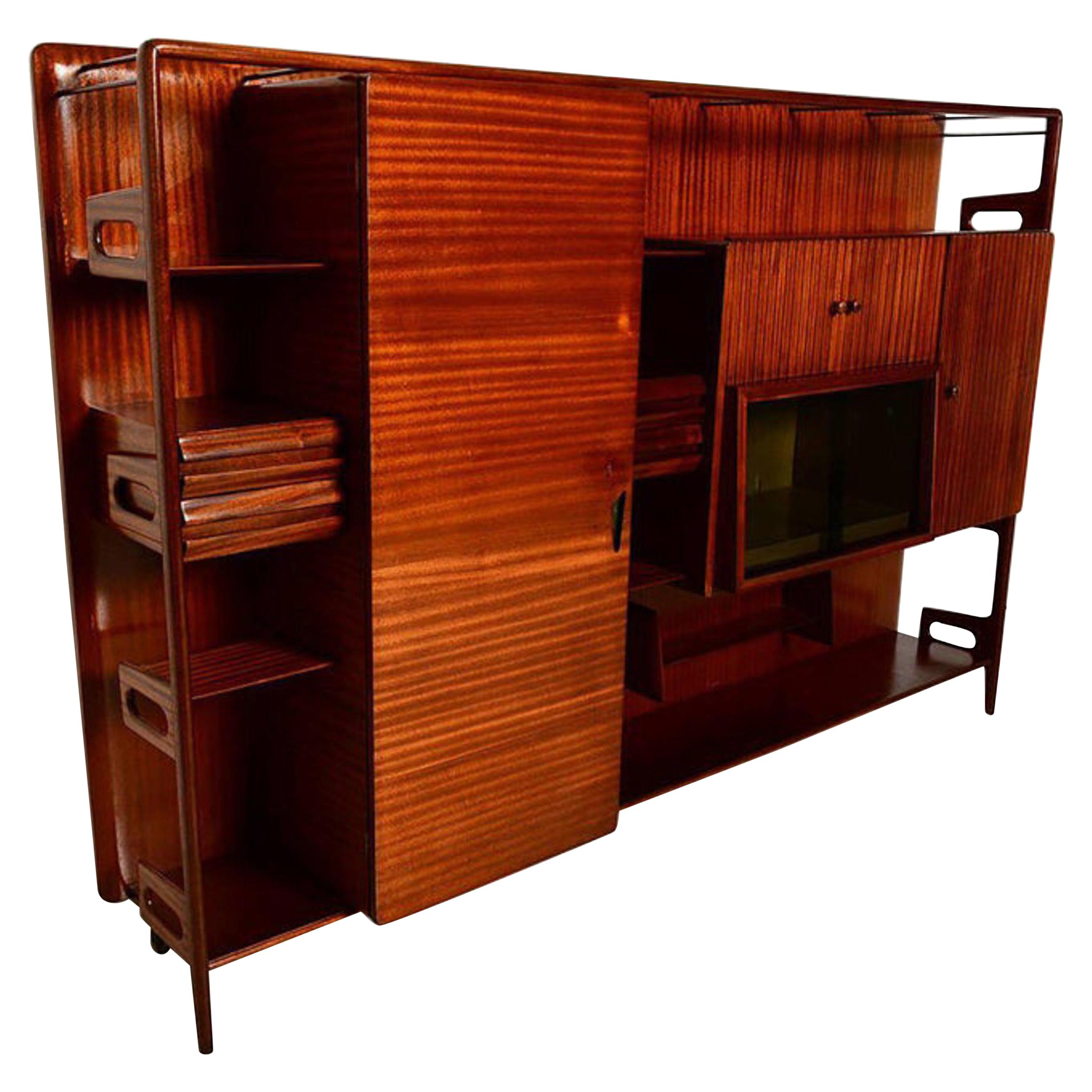 Fine Italian Wall Unit in exotic sapele mahogany Vittorio Dassi ITALY
Unmarked, attribution Vittorio Dassi for DASSI circa 1950s.
Sculptural shape wall cabinet features multiple drawers, storage & open shelving.
Sensational wood grain luster, fine