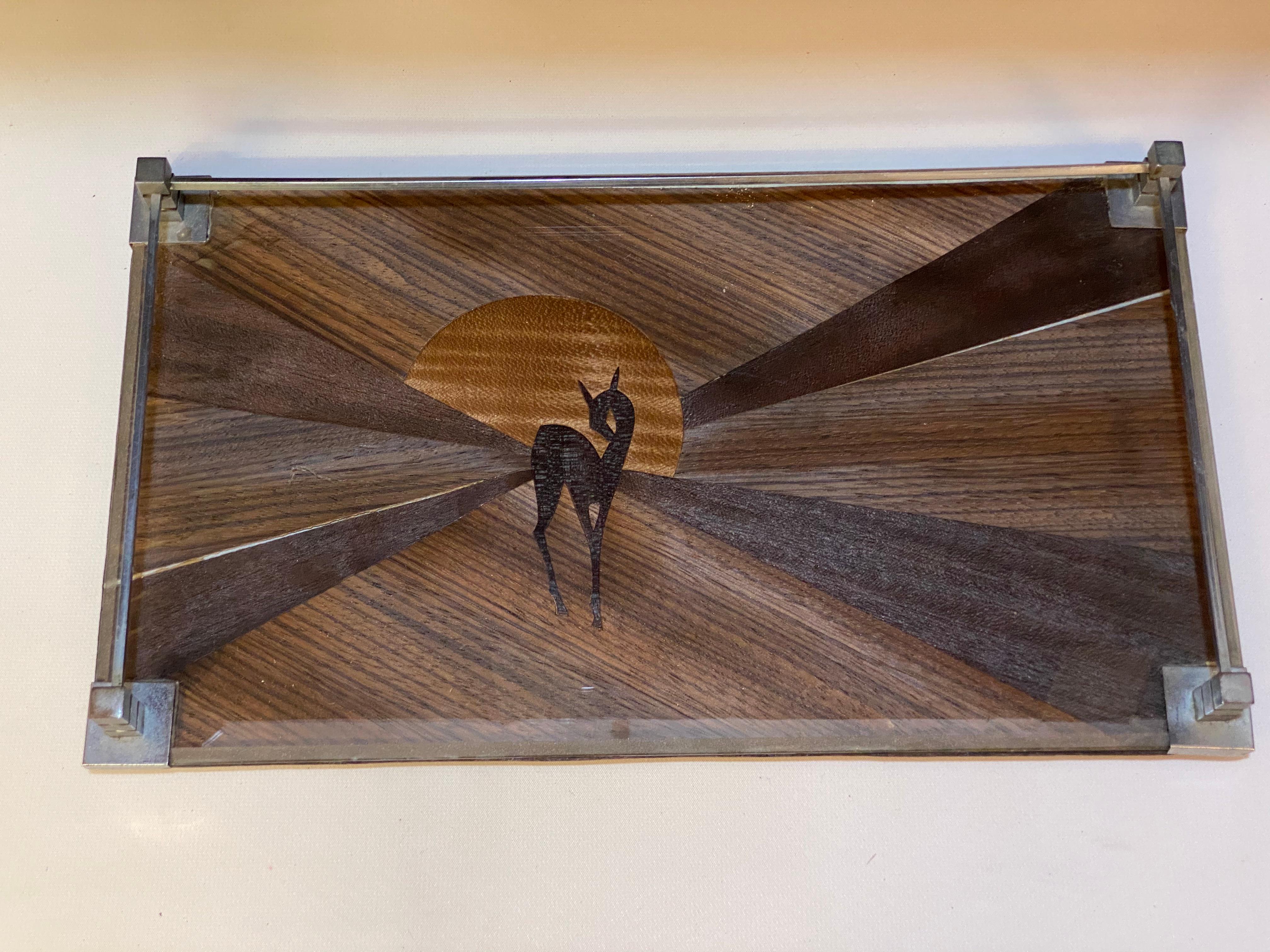 Made of exotic hardwoods and constructed into a wonderful Art Deco table top or desk top tray. The fully figured and densely grained hardwoods. Angela and Dr. Winogradow have rendered a sweet arrangement of a stylized faun with radiating arms of