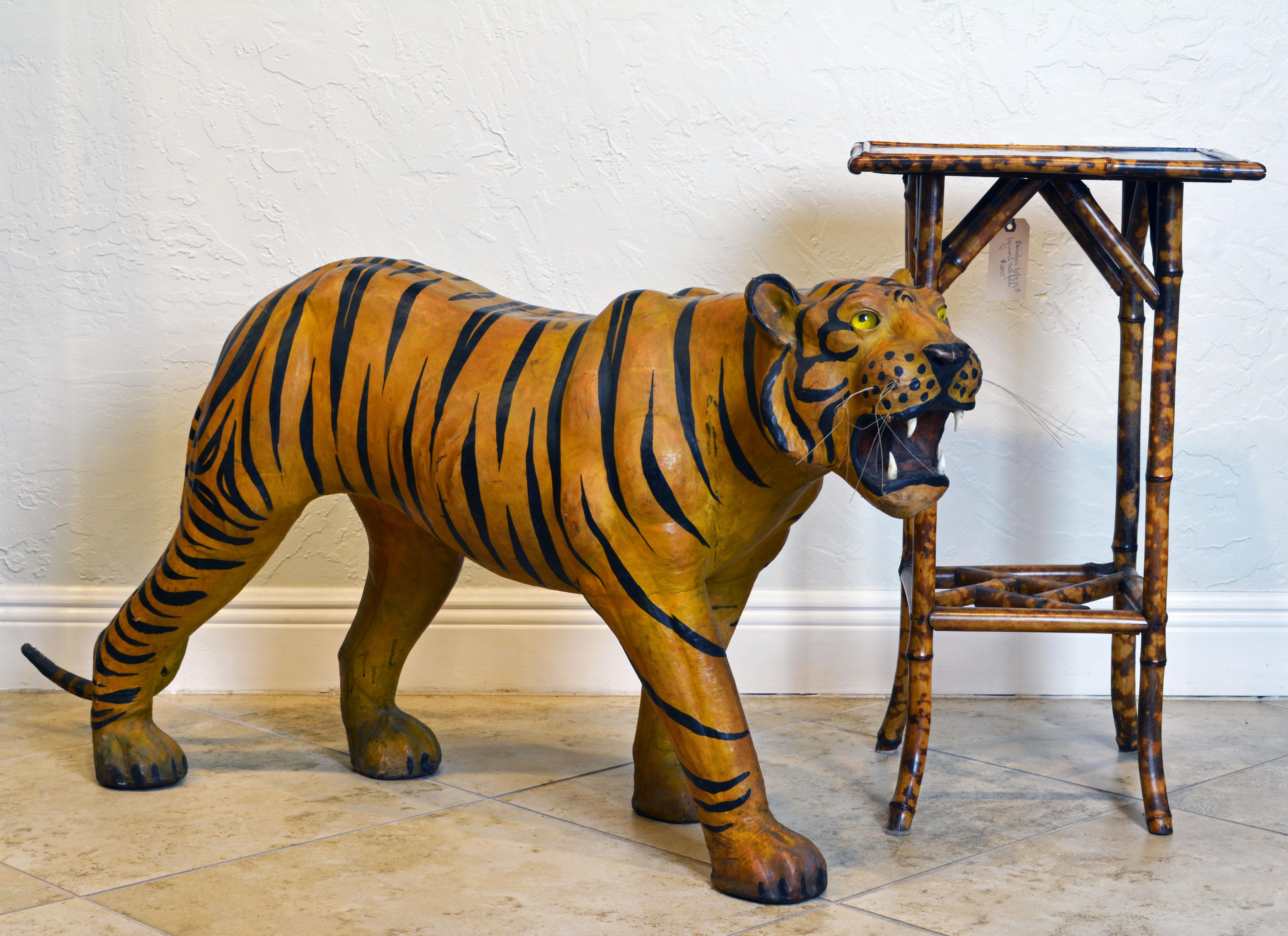 This epic 1960s leather wrapped sculpture of a Bengal Tiger with glass eyes, whiskers and teeth is most likely made in India for the English market. Being 55 inches long and 24 inches tall it makes a great exotic impression.