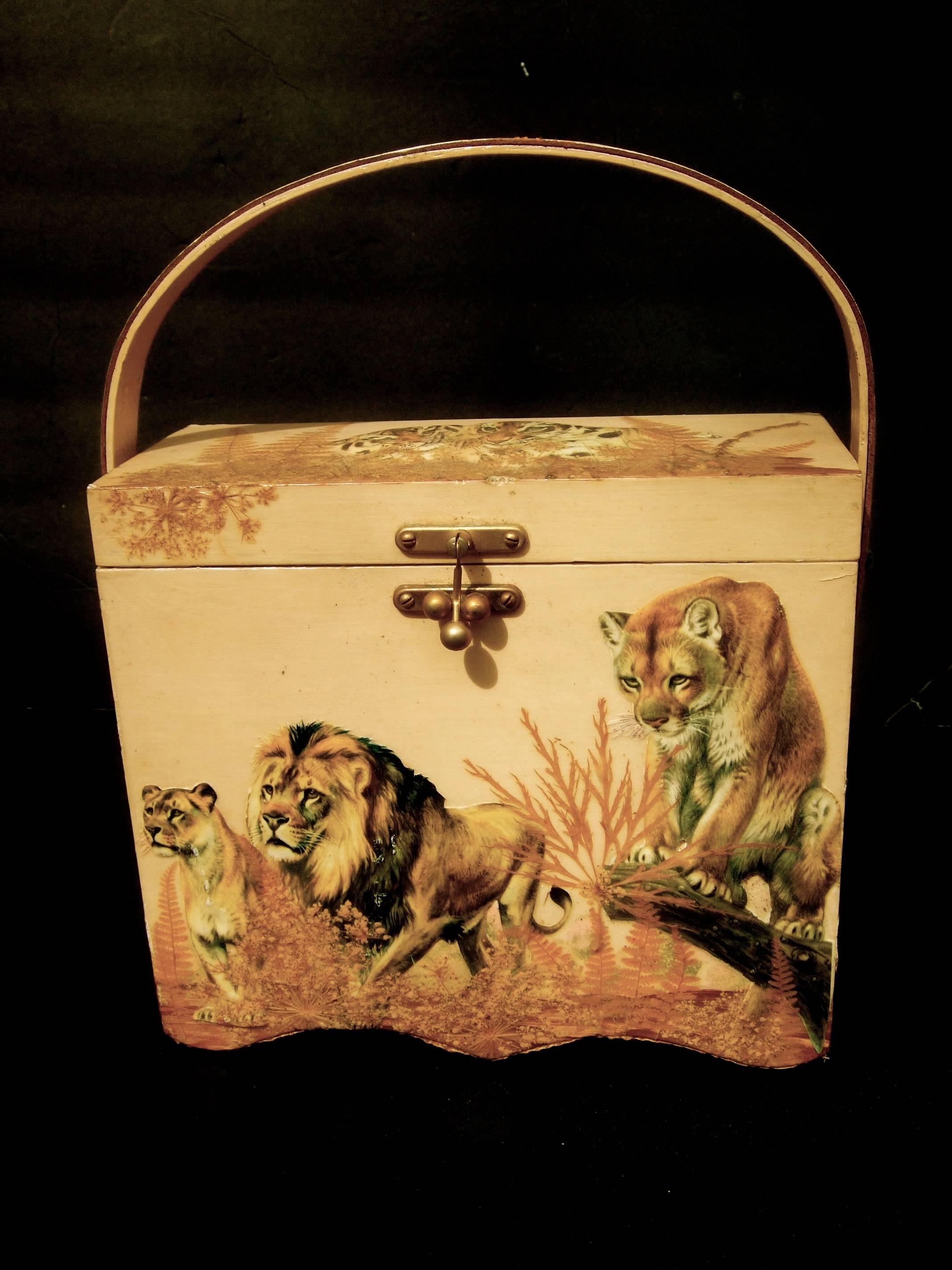 Exotic jungle safari theme wood decoupage box purse c 1970s
The unique rectangular shaped wood box purse is decorated
with wild jungle animals in three dimensional decoupage

The interior is lined with cloth animal print fabric
Carried with a swivel