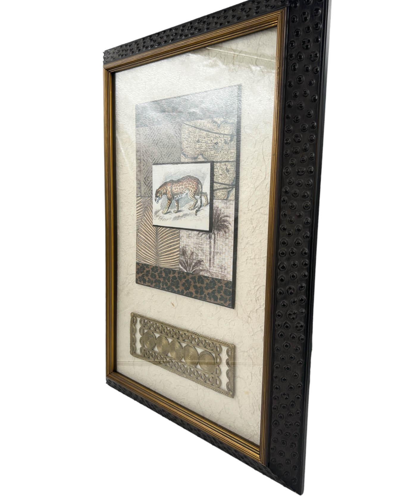 A  mixed media collage by design house JOHN RICHARD. This piece combines elements of nature, featuring a depiction of a leopard crafted on bark paper. The collage is encased behind glass and  framed in an ostrich-style frame made of bone. Using