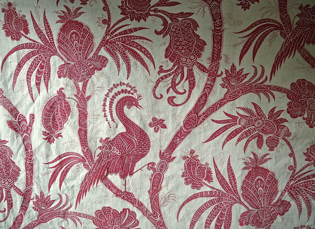 Large early 19th century French single curtain printed with a striking indienne design of large-scale exotic birds and flowers on meandering branches. Originally part of a set of bed hangings for a four poster bed it retains its gathered top edge