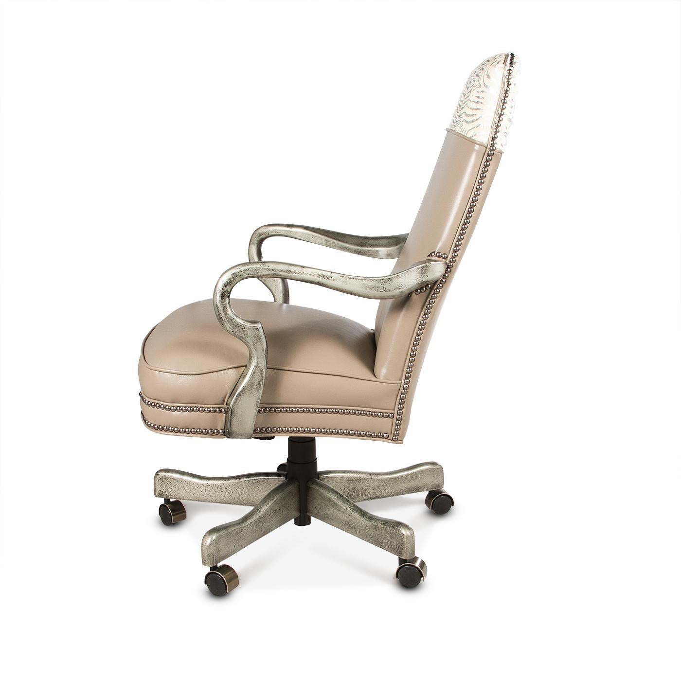 This one-of-a-kind silver leather office chair is made with top grain high-quality leather with an exotic silver leafed hair on hyde. The high back office chair has natural brass nailhead details and the shepherd's crook arm is finished in our dark