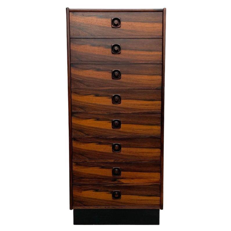 Exotic tall chest
Lean wardrobe chest of drawers. Made in Sweden 1970s
Constructed in exotic Brazilian rosewood. A total of eight (8) drawers. All the drawers are constructed in dovetail joinery.
Sculptural wood handles in Brazilian rosewood