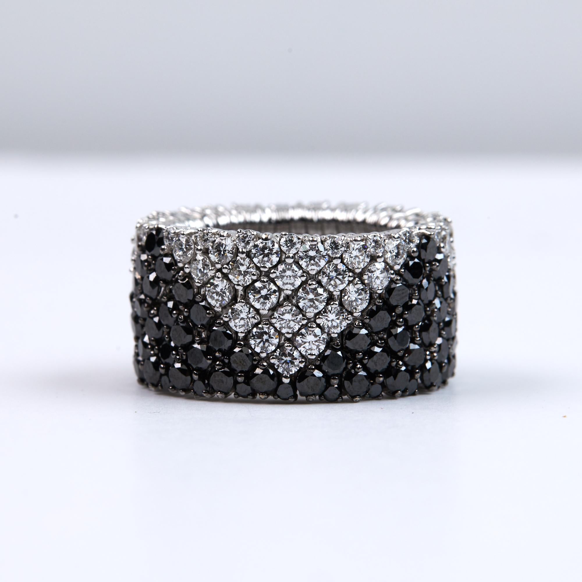 Expandable and Flexible Fit Black and White Diamond Band Ring. This large stretch ring has 4.47 carats of Brilliant round Cut Diamonds and an additional 3.30 carats of Brilliant Round White Diamonds set in a geometrical pattern. The diamonds are F-G