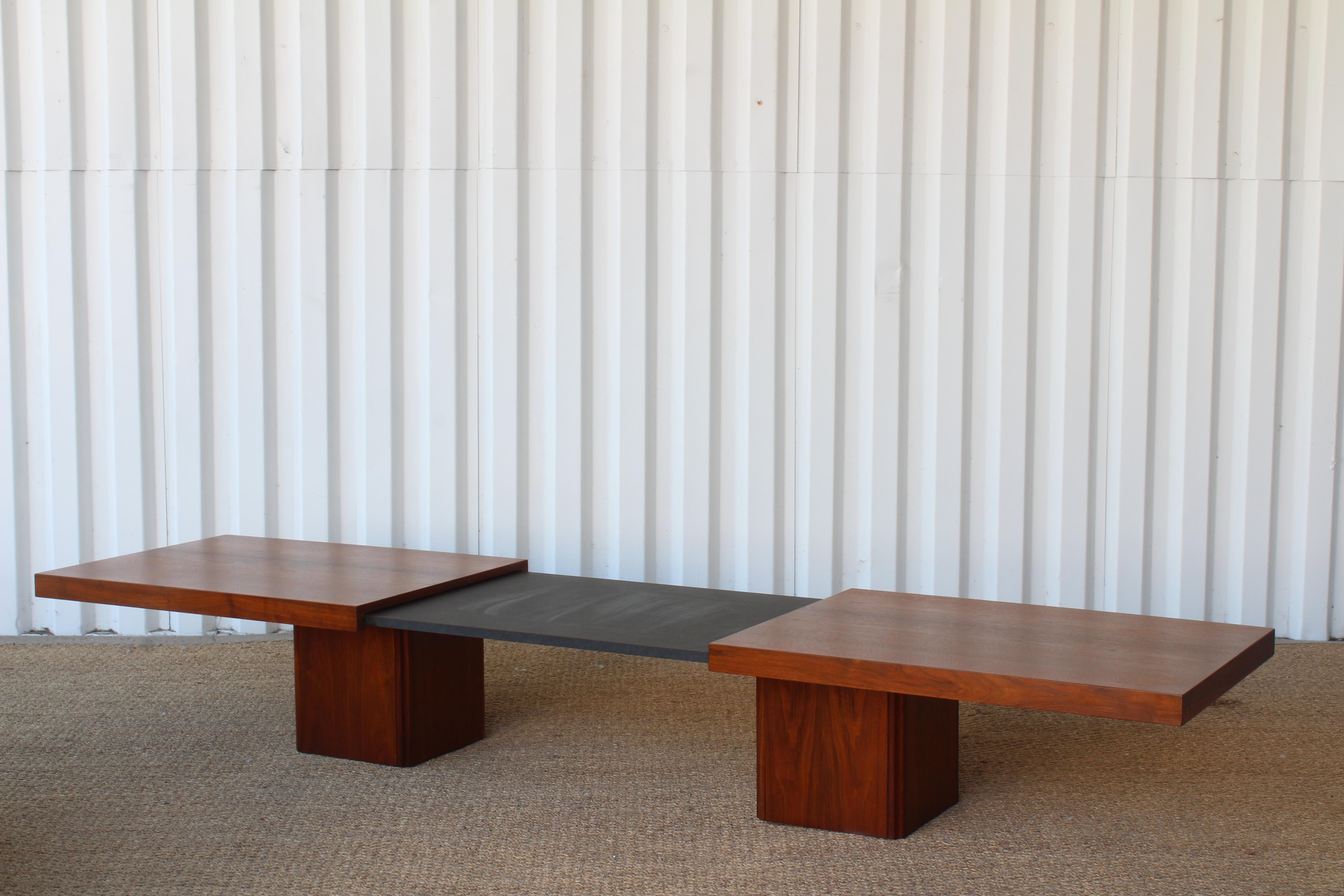1960s expandable coffee table in walnut, designed by John Keal for Brown Saltman, U.S.A expands to reveal a laminate surface underneath. Measures from 66