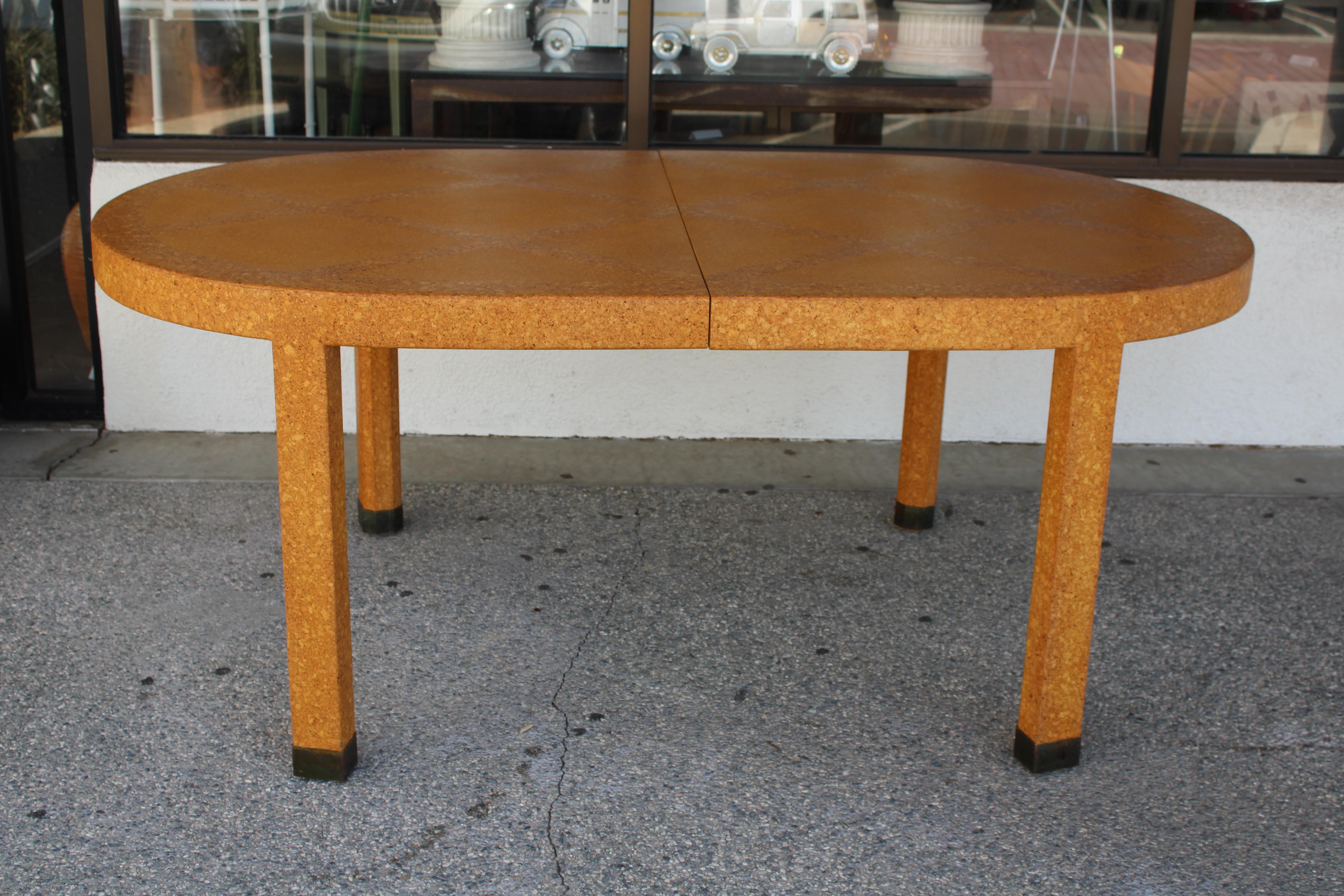 Expandable cork dining table attributed to Paul Frankl. Table has 2 leaves each measuring 22