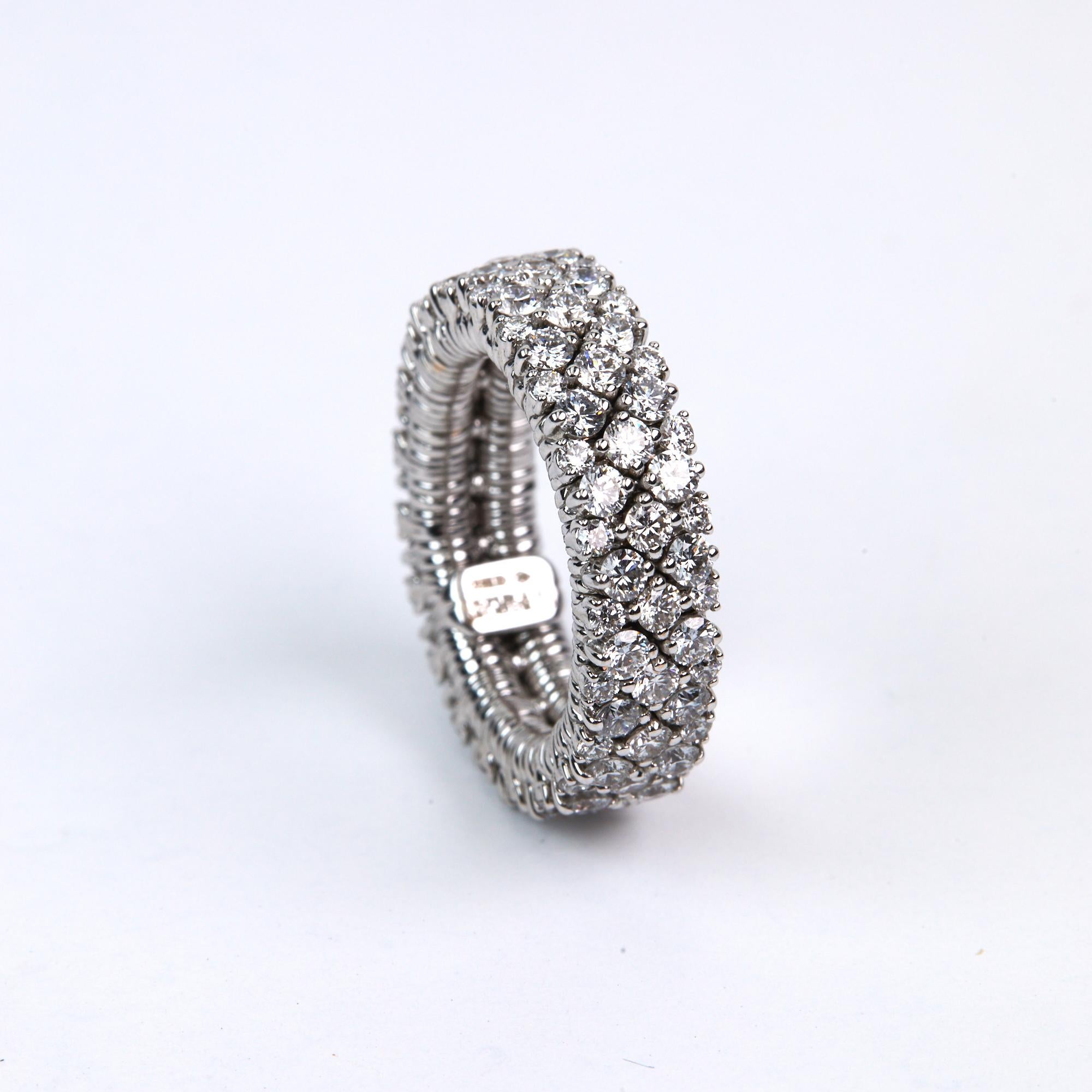 Expandable and Flexible Diamond Band ring with 3.48 carats of Brilliant Round Cut Diamonds set in 18 karat white gold. This trademarked technology takes medical grade stainless steel springs and strings bars of white gold with prong set diamonds to