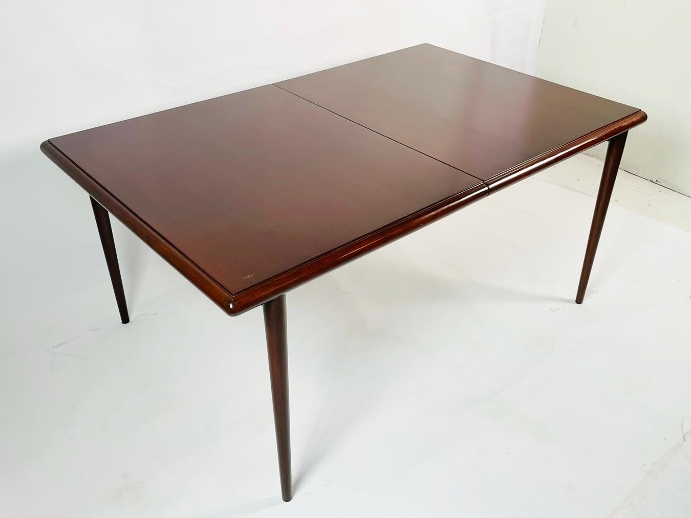 Vintage dining table with one additional leaf, designed by T.H. Robsjohn-Gibbings in the early 1950's.

The table is well design/built, perfect for condos/apartments.

The table was refinished and never used but have sat in storage for quite