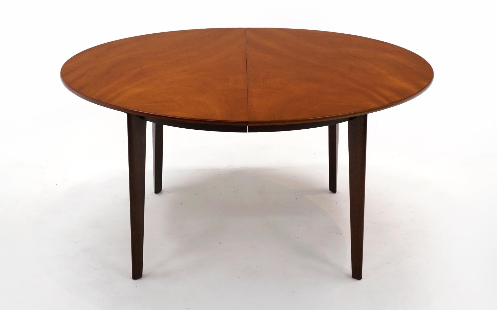Exceptional expanding dining table designed by Edward Wormley and manufactured by Dunbar, 1950s. Each leaf is 24 inches wide. Table fully extended is 129 inches wide. This is one of the best dining tables we've handled in our 25 years in business.