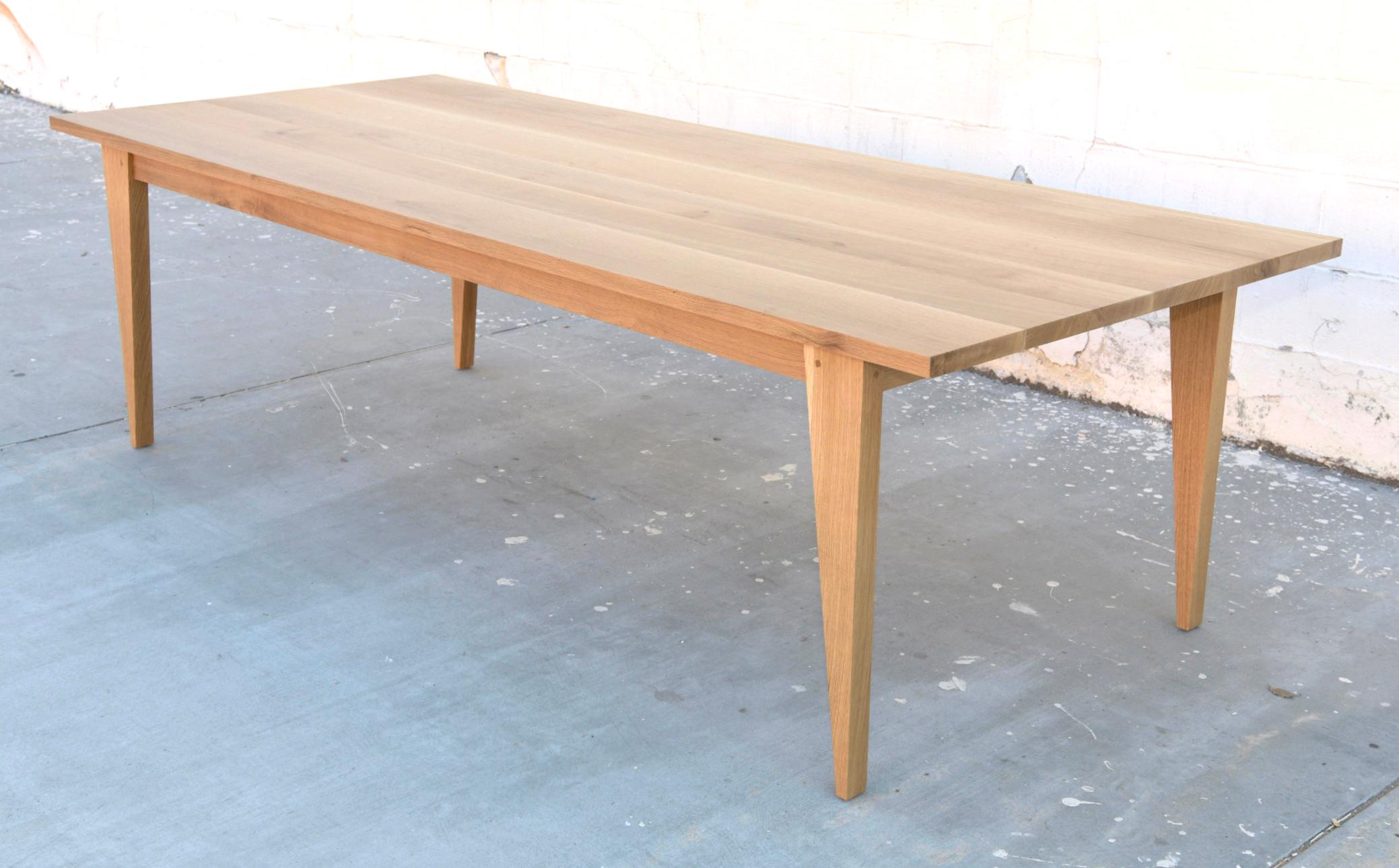 This custom dining table made from quarter sawn oak expands from 96