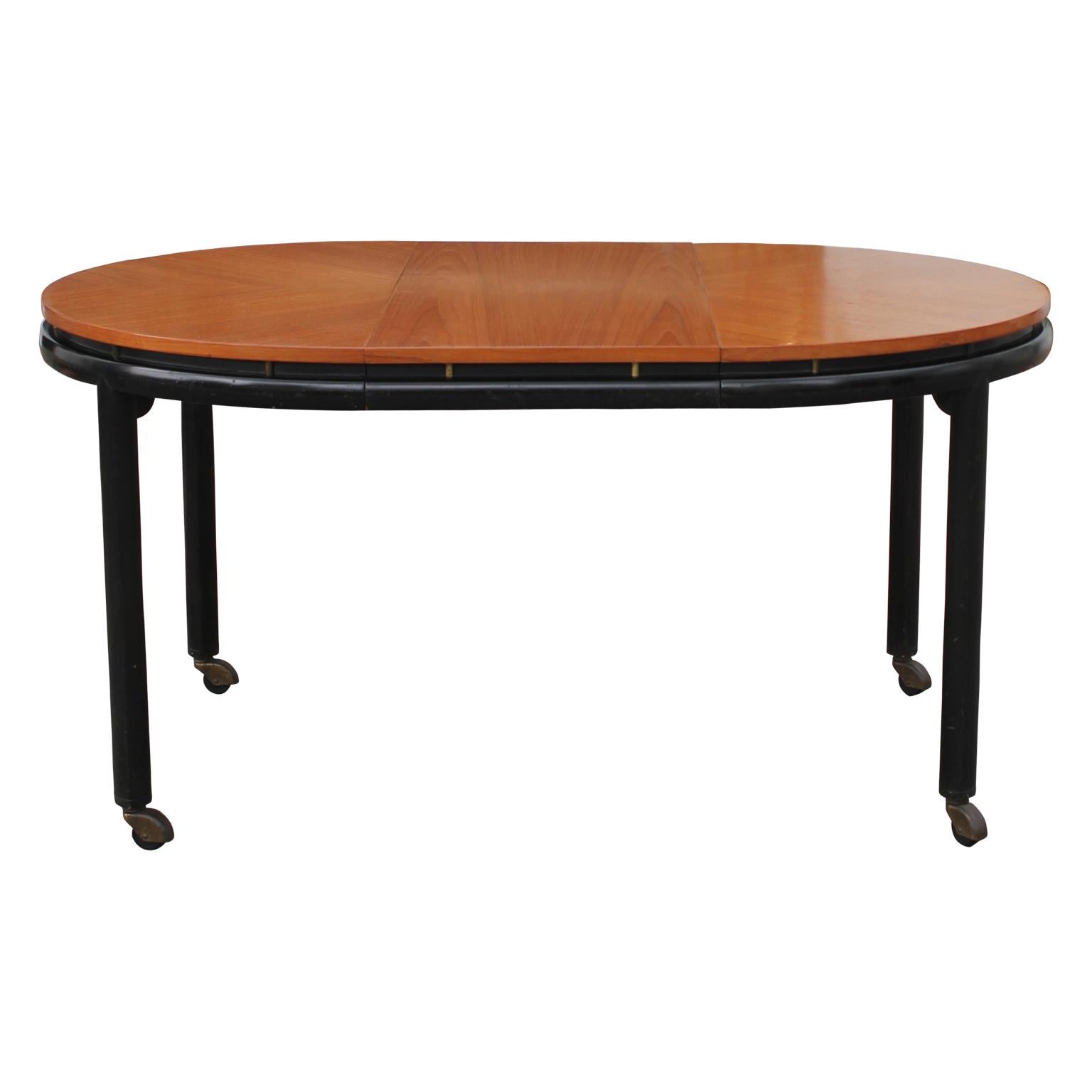 Phenomenal oval table from the New World collection. It is by Michael Taylor for baker furniture and features a removable leaf. Matching chairs are also available from our shop.

Measurements with the leaf inserted 58