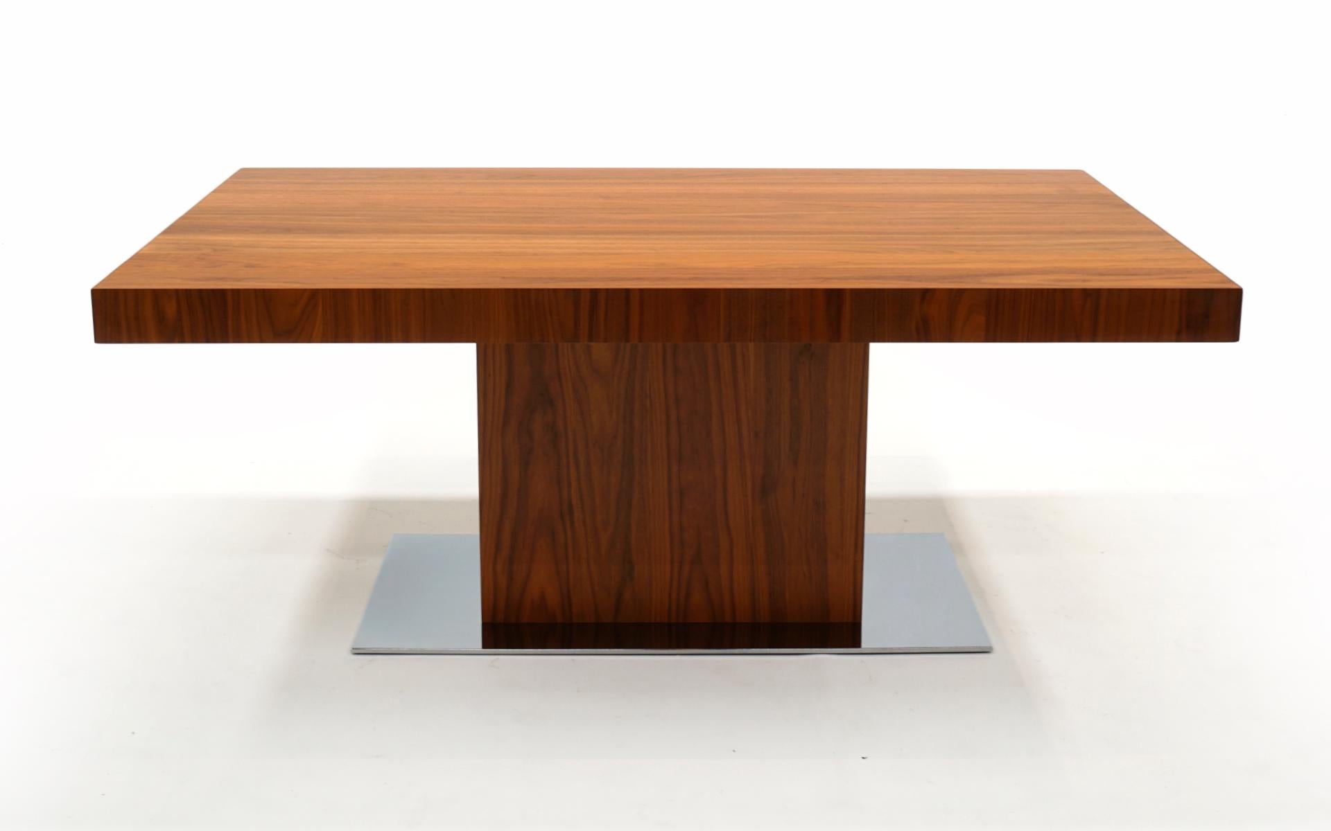 Stunning walnut dining table with chrome platform base by Calligaris, Italy.  Super heavy duty construction.  See the video for how the internal skirted leaves come out and back in.  Great condition, light scratches may be visible on very close