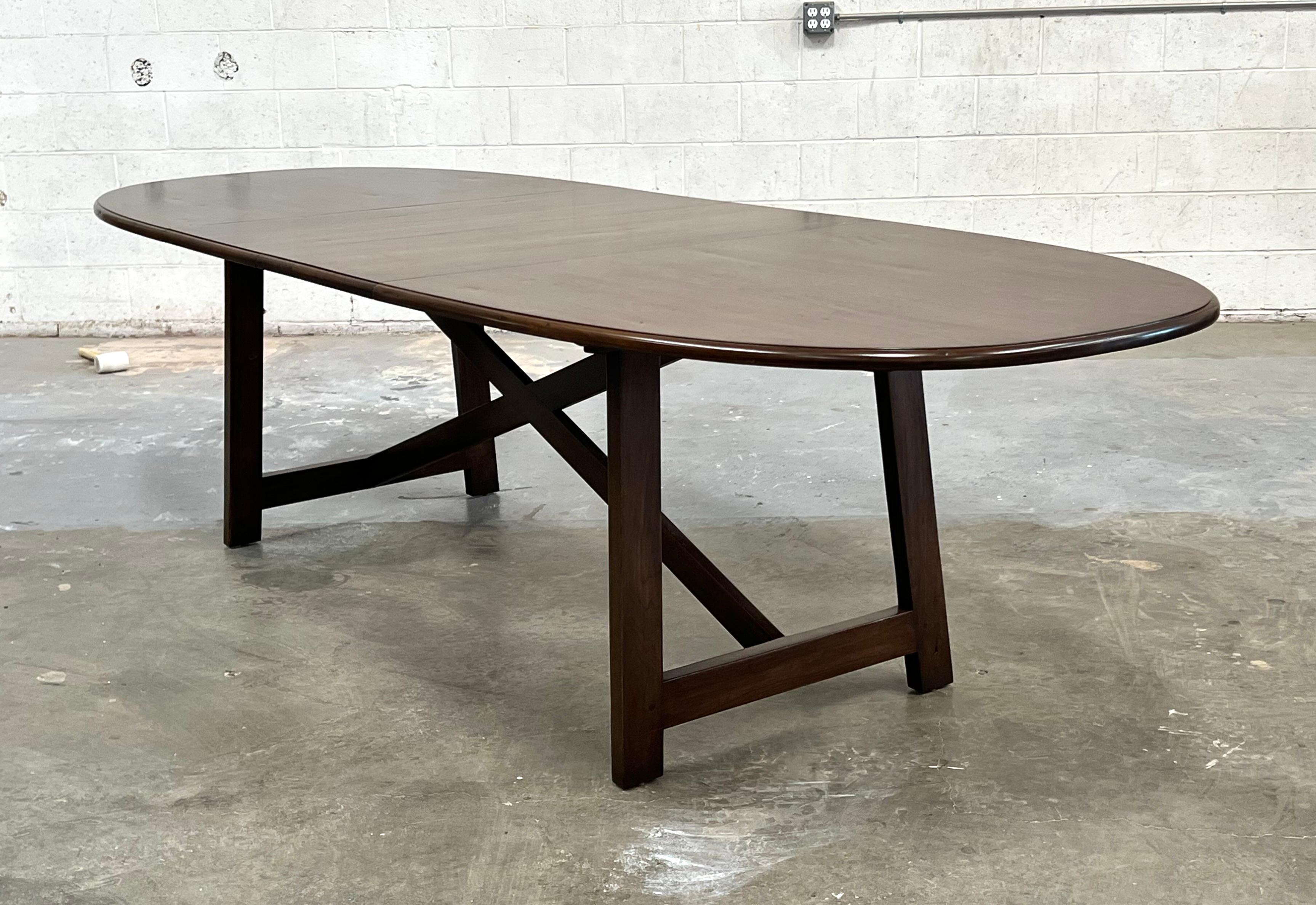 This walnut dining table expands from 84