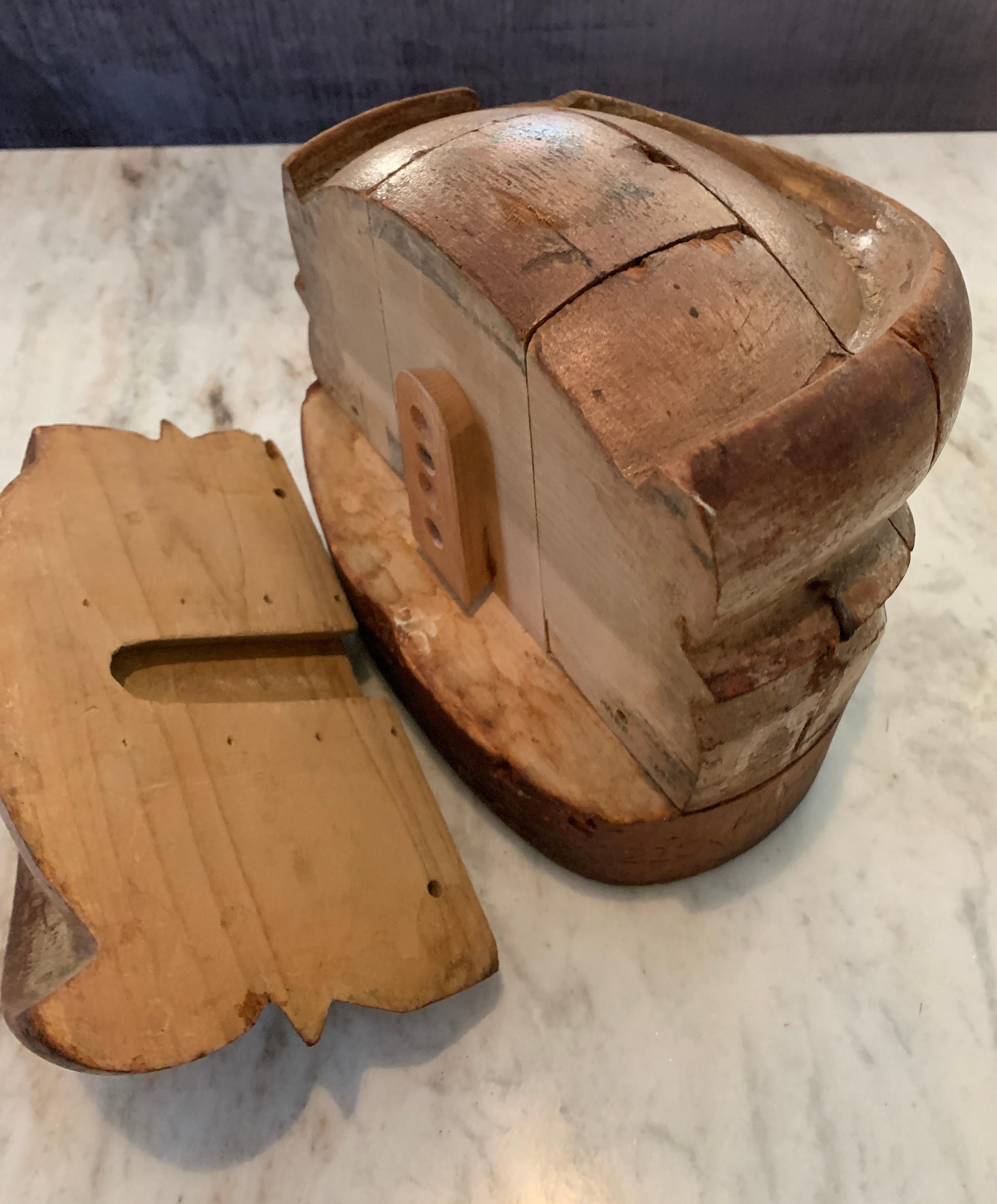 Wooden adjustable French vintage Milliner hat form. Great for use as a hat rack, a bookend or decorative item. The form, like a puzzle, comes apart. All wood and wonderful patina.