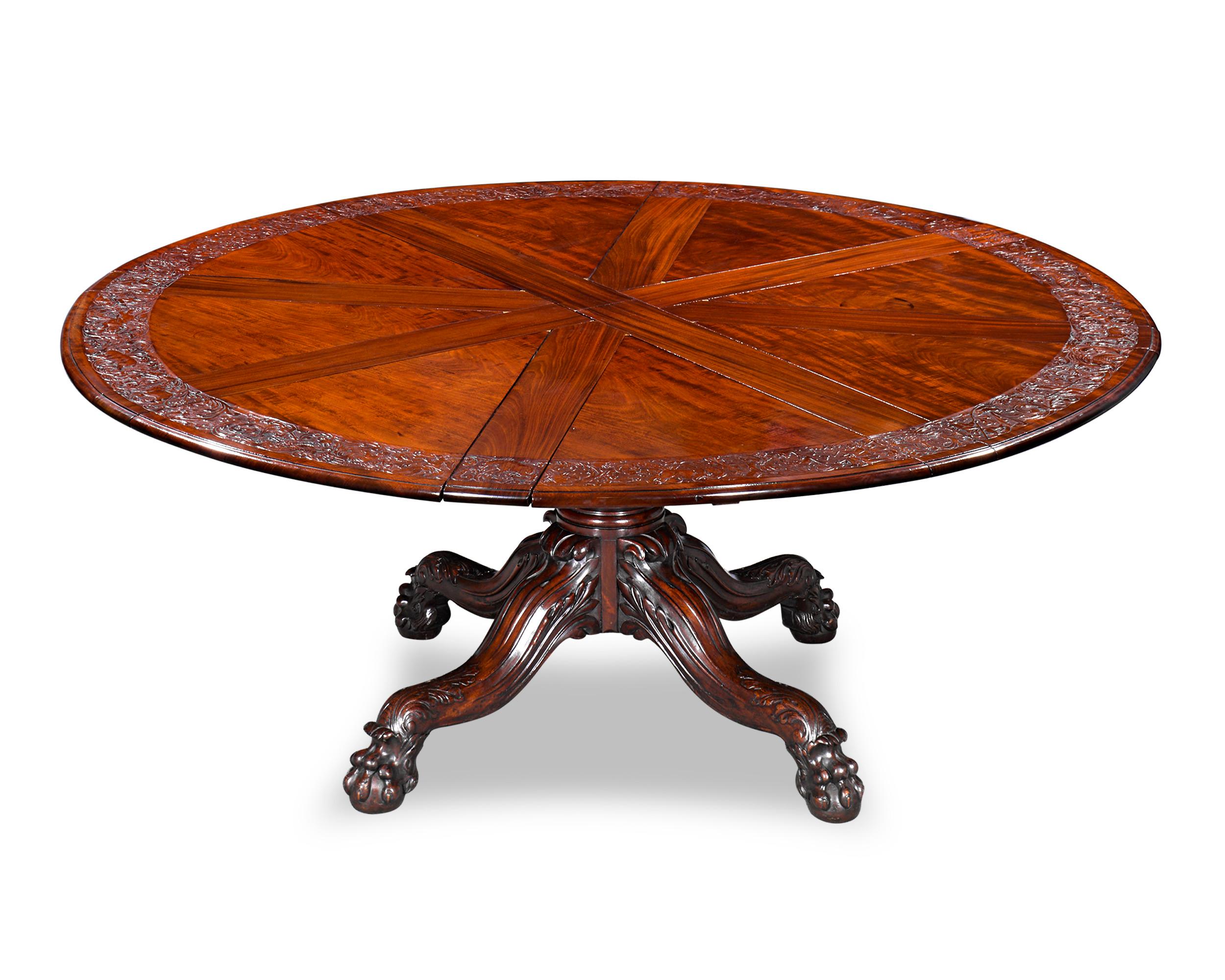 This exceptionally rare circular expanding dining table was designed by Robert Jupe and crafted by the English cabinetmakers Johnstone & Jeanes, successors to Johnstone, Jupe & Co. One of only a handful known from the firm, this table illustrates