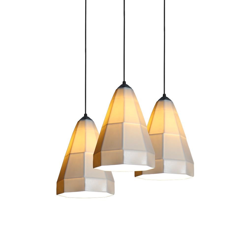 Three 11 inch hanging pendant cluster from the Expansion collection, the cone shape of the expansion 1 pendant spreads white, direct light downward while the shade emits a glow at eye level. Perfect for handing over a dining booth in a home or