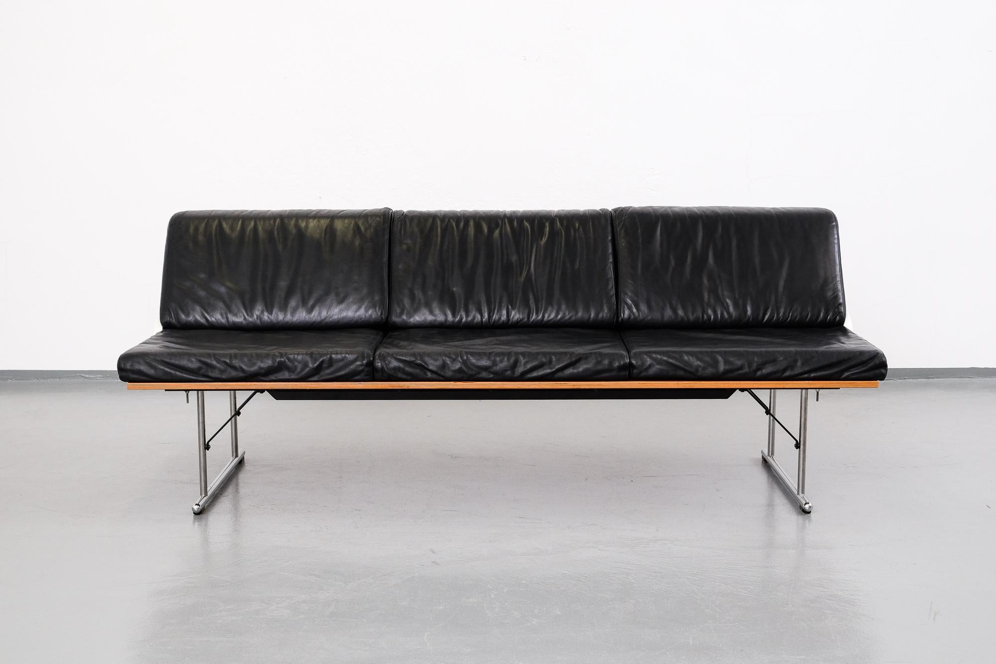 This 'Experiment' series 3-seat sofa was designed by Yrjö Kukkapuro in 1982 for Avarte in Finland. It is made from chromed tubular steel frame, clear lacquered plywood seat and black leather upholstery, the armrest are made of white lacquered curved