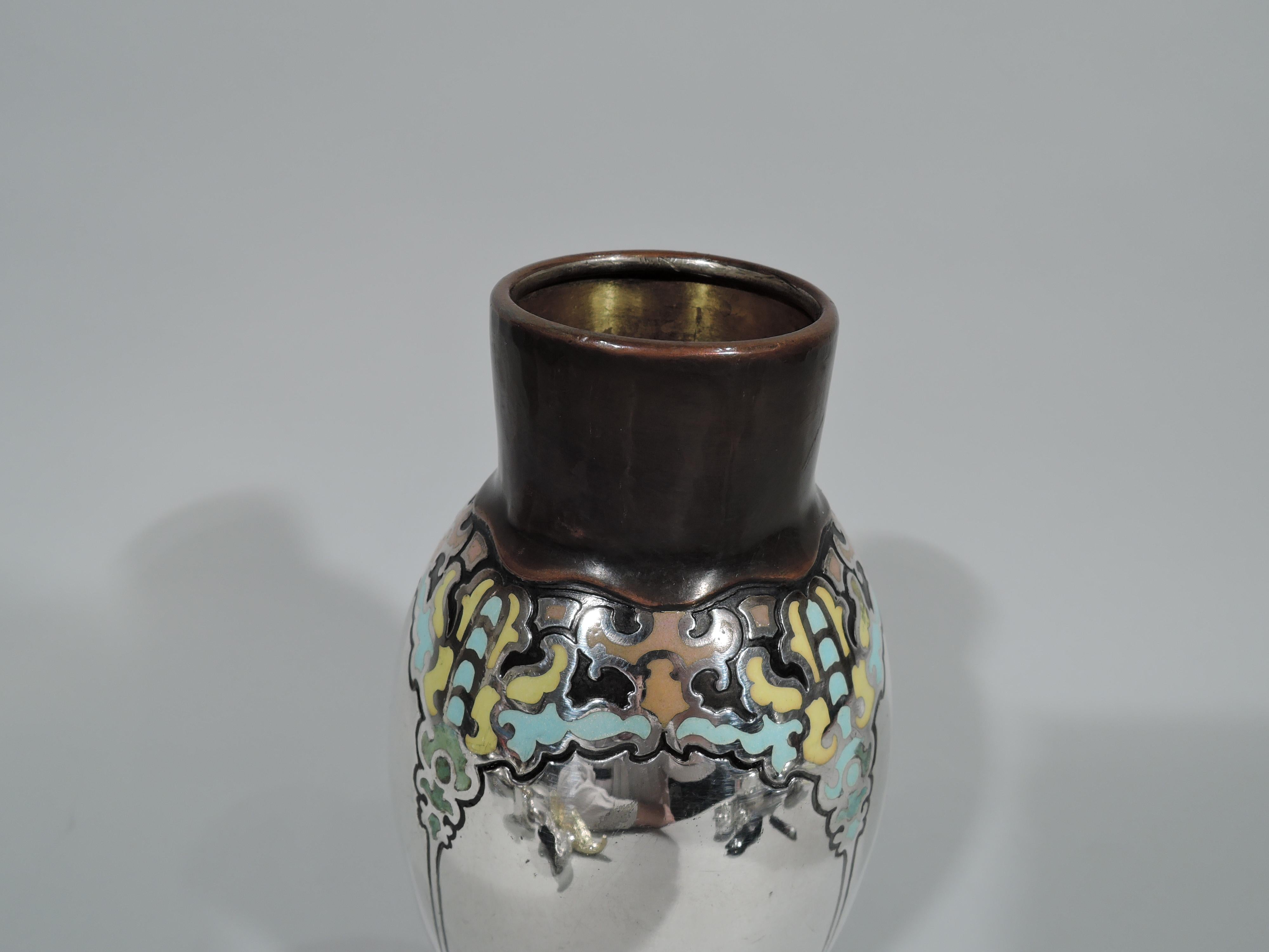 Art Nouveau mixed metal and enamel vase. Made by Tiffany & Co. in New York, circa 1910. Sterling silver baluster enameled with ornamental frames. Copper base engraved with dense and fluid fretwork bands. Copper neck with fluid “drip” mount. A