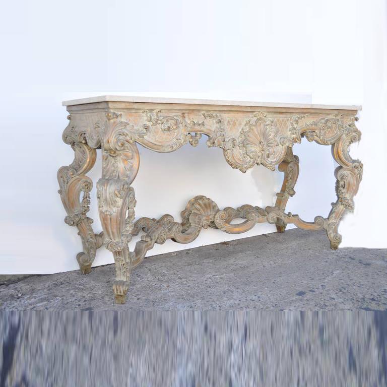 A Stunning, Early 1900s, Exquisitely Carved French or Italian Marble Top Console Table in the Rococo / Louis XV Taste. This breathtaking console features elaborate and very fine carvings throughout including acanthus scrollwork, floral drapes, deep