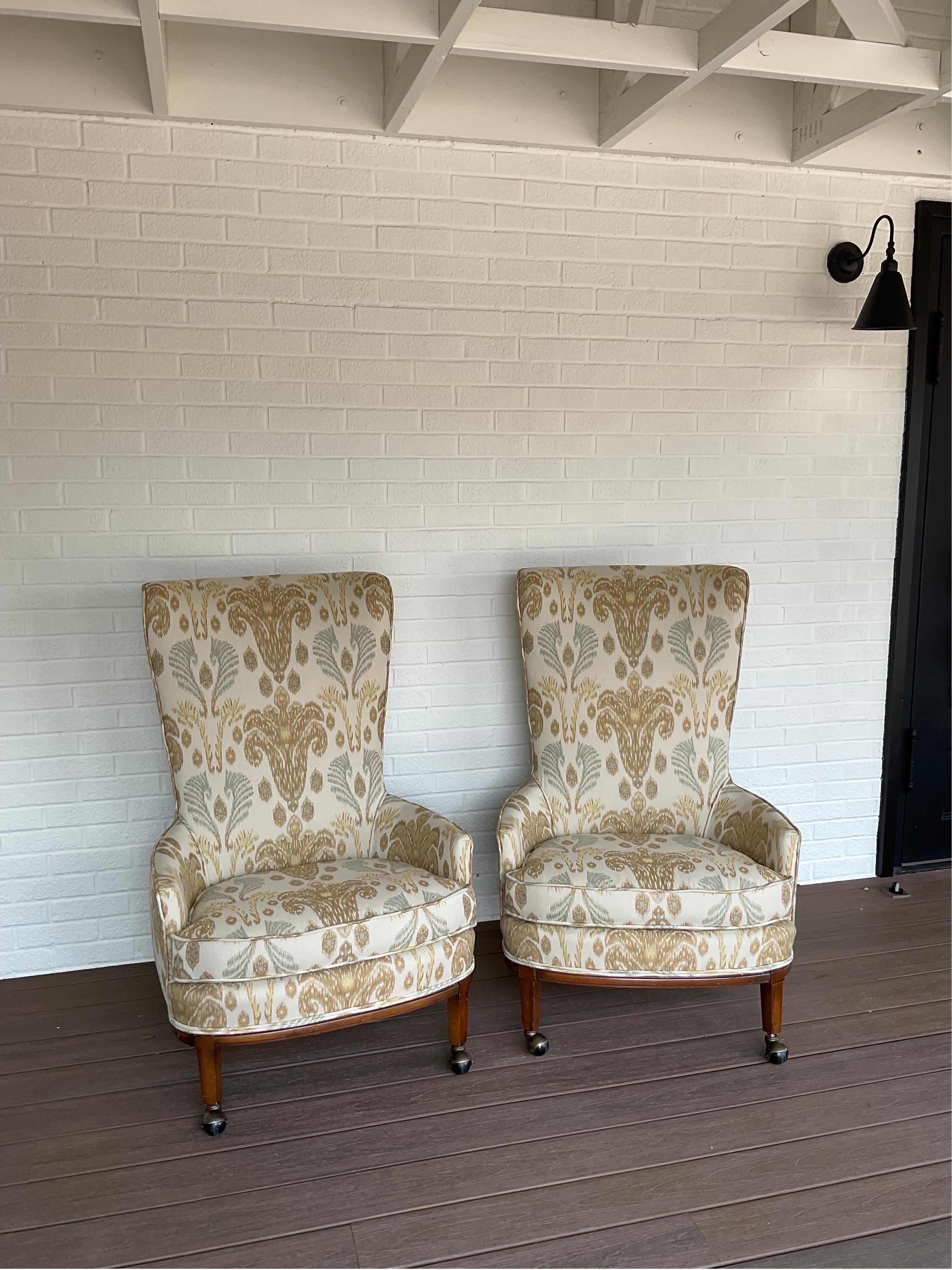 Fantastic pair of MCM club chairs with a high rounded back and art deco influence. Chairs are on the original casters. Fresh from the upholstery shop and wrapped in an incredible Ciara Ikat Kilimanjaro Jacquard. Beautiful chairs circa