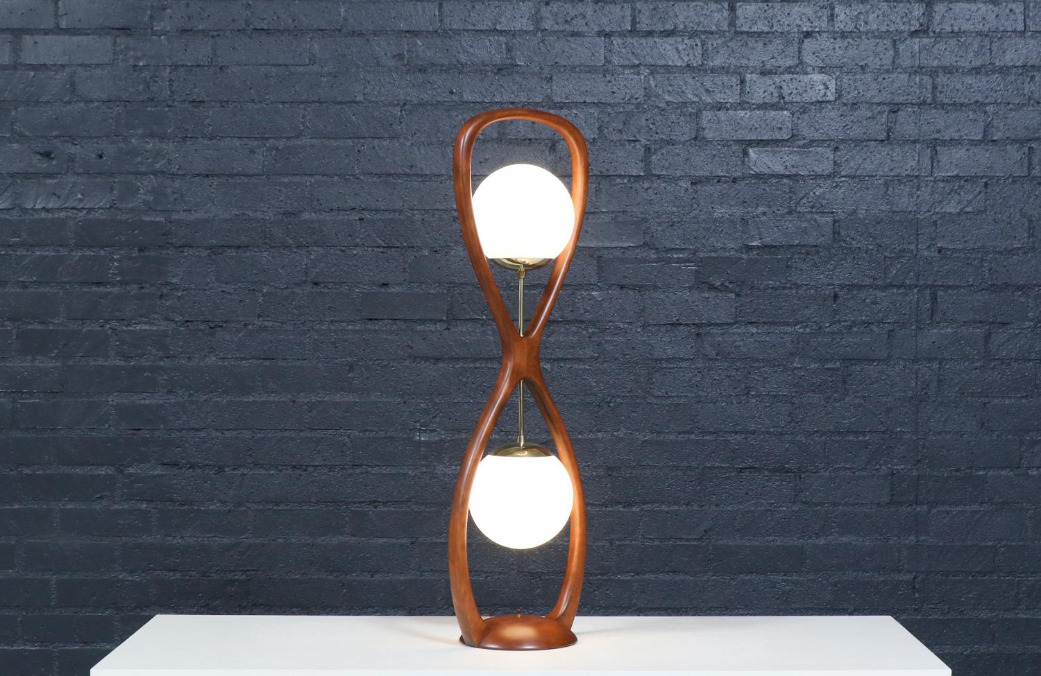 Materials
Korina Wood, Original Frosted Glass Globes, Brass Hardware
________________________________________

Transforming a piece of Mid-Century Modern furniture is like bringing history back to life, and we take this journey with passion and