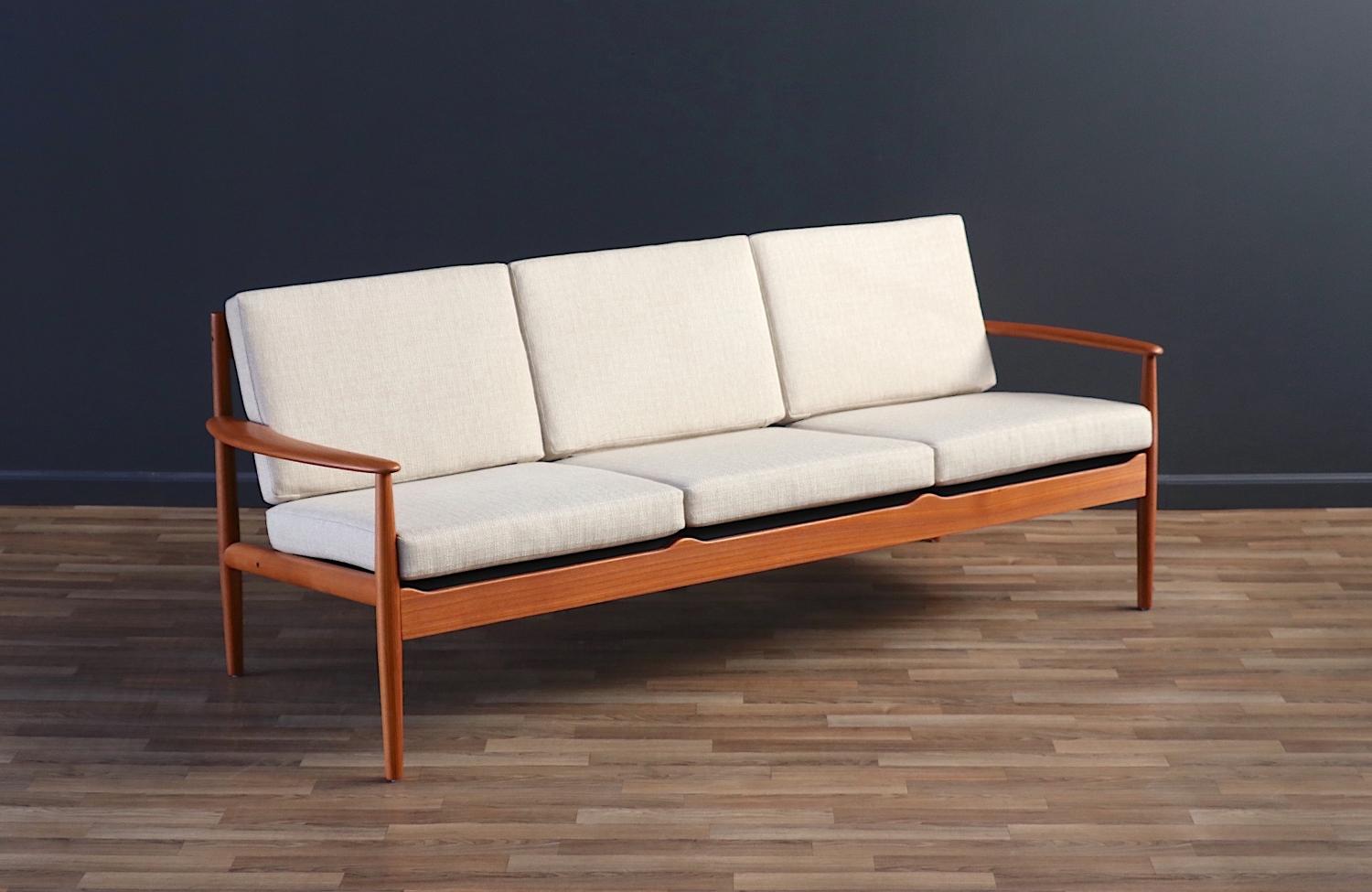 Enhance your space with this Danish Modern sofa designed by Grete Jalk for France & Søn, crafted in the 1960s. Made from premium teak wood, it features new tweed fabric upholstery and new springs. Newly refinished and reupholstered, this sofa