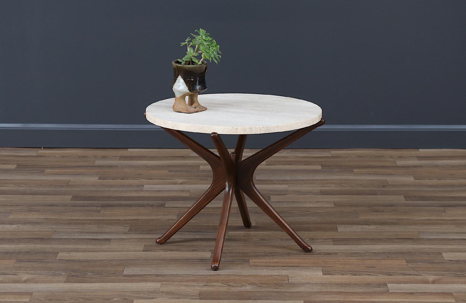 Elevate your space with the Mid-Century Sculptural Jax Side Table, crafted in Italy in the 1960s. Featuring a sculpted walnut wood base and an original travertine stone top, this table combines elegance and functionality. Newly refinished and in