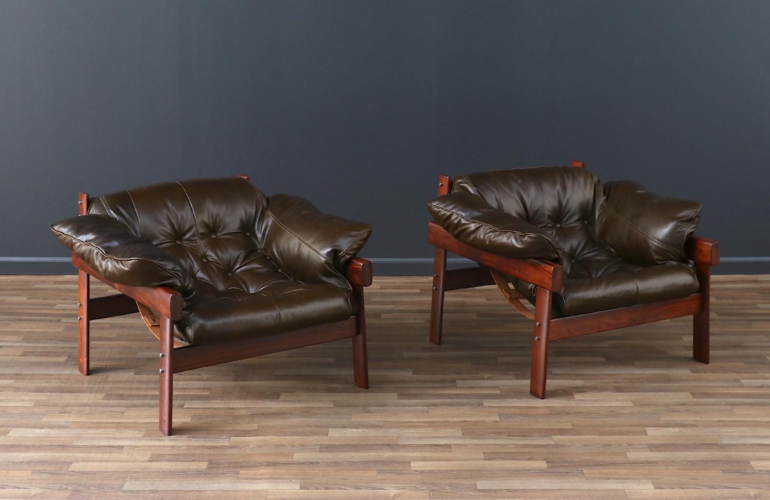 MP-41 Lounge chairs designed and manufactured by Percival Lafer in Brazil circa 1970’s. These chairs have a solid mahogany wood frame with a chrome steel underframe with new leather straps that support the newly upholstered cushion. The Dark Olive