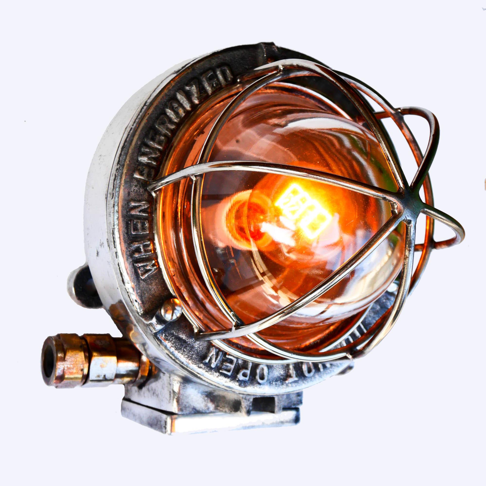 Old industrial wall light, from USA. Made of cast aluminium, picked and polished, curved fence protecting a thick curved transparent glass.