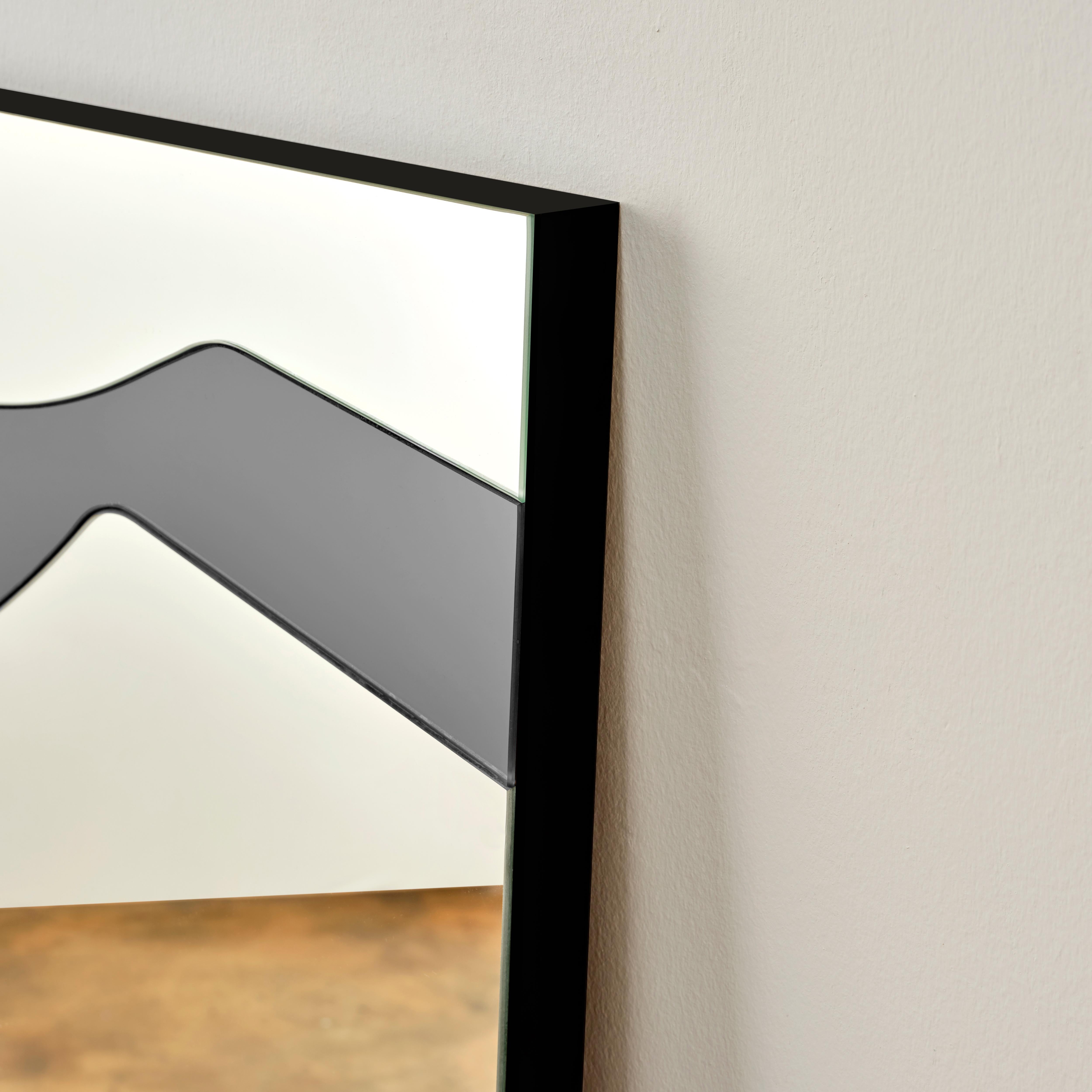 Exposè mirror is made of two large different colored glasses cut into many smaller segments and joint together by hand in order to create a juxtaposed image. Highlighting the line between art and function, this is a unique piece that plays with the