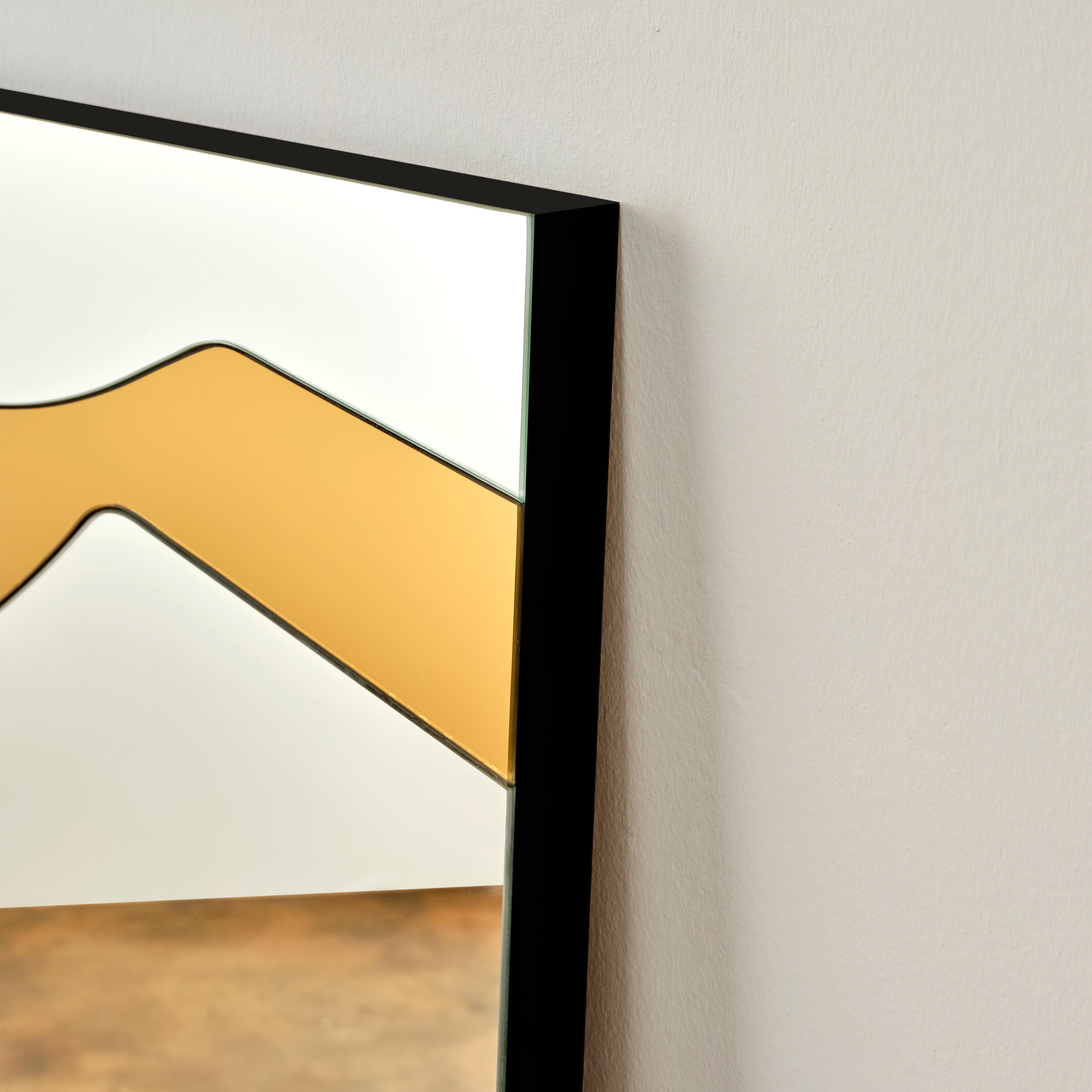 Exposè mirror is made of two large different colored glasses cut into many smaller segments and joint together by hand in order to create a juxtaposed image. Highlighting the line between art and function, this is a unique piece that plays with the