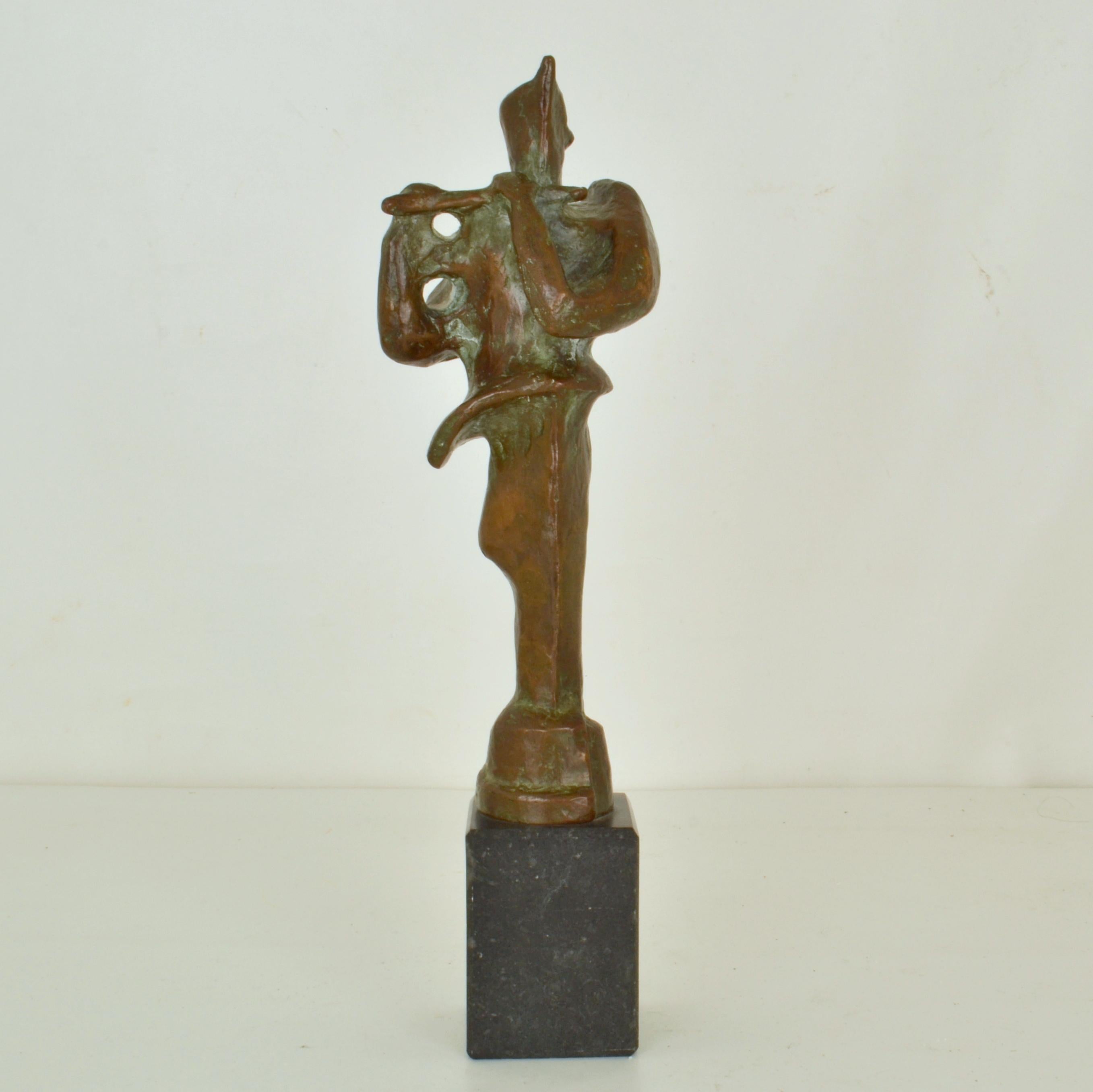Sculpture of a flute player is cast in bronze stands on a black marble base by Adler 1960's. It is expressive with its original patina and will make a beautiful feature. 
There are many mythological stories involving the flute player. In ancient