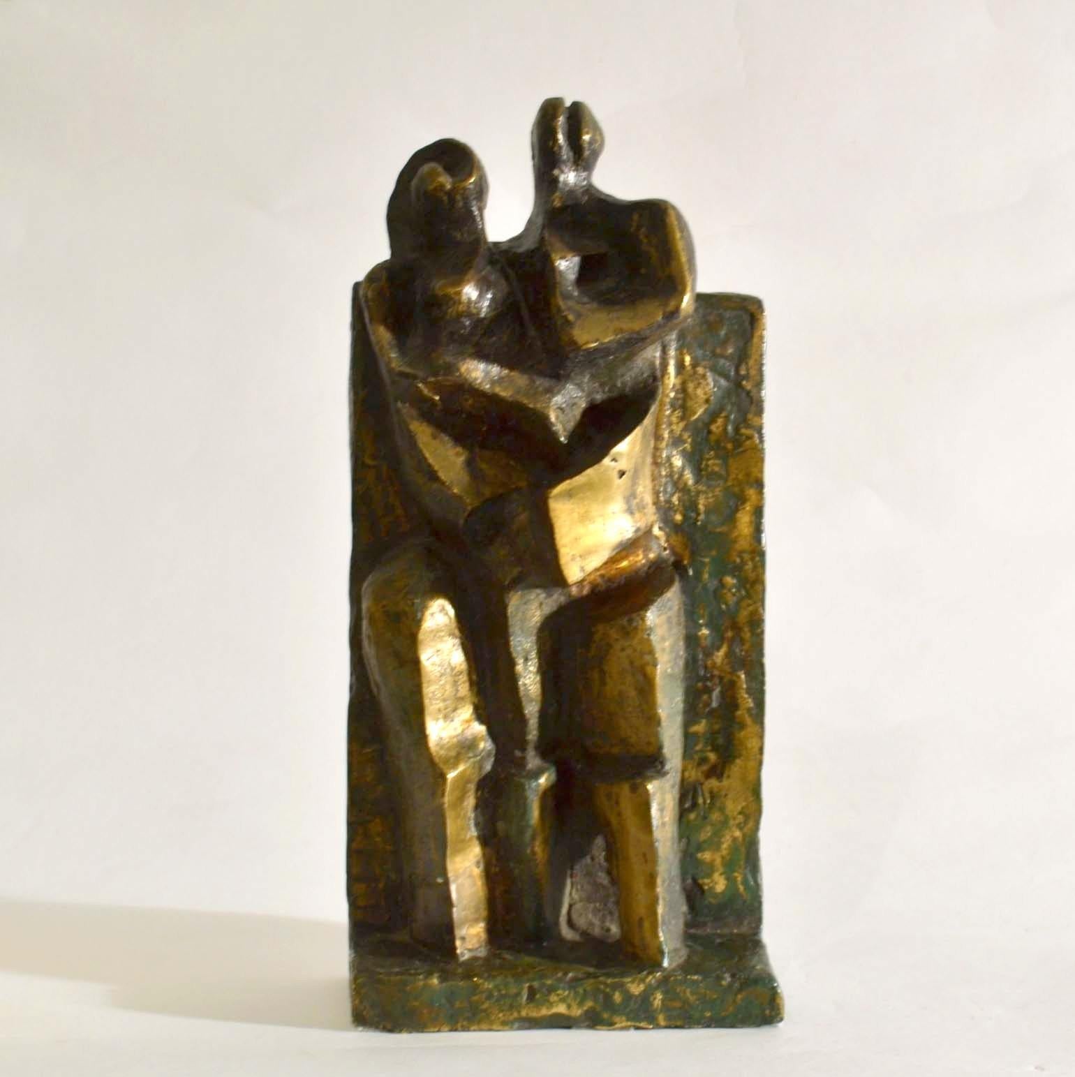 Intimate bronze sculpture of a standing couple with child is framed by a rectangular wall which continues into the base acts as the setting of the bronzeis  expressionist / cubist style . The sculpture with its contrasting patina, textures emphasize