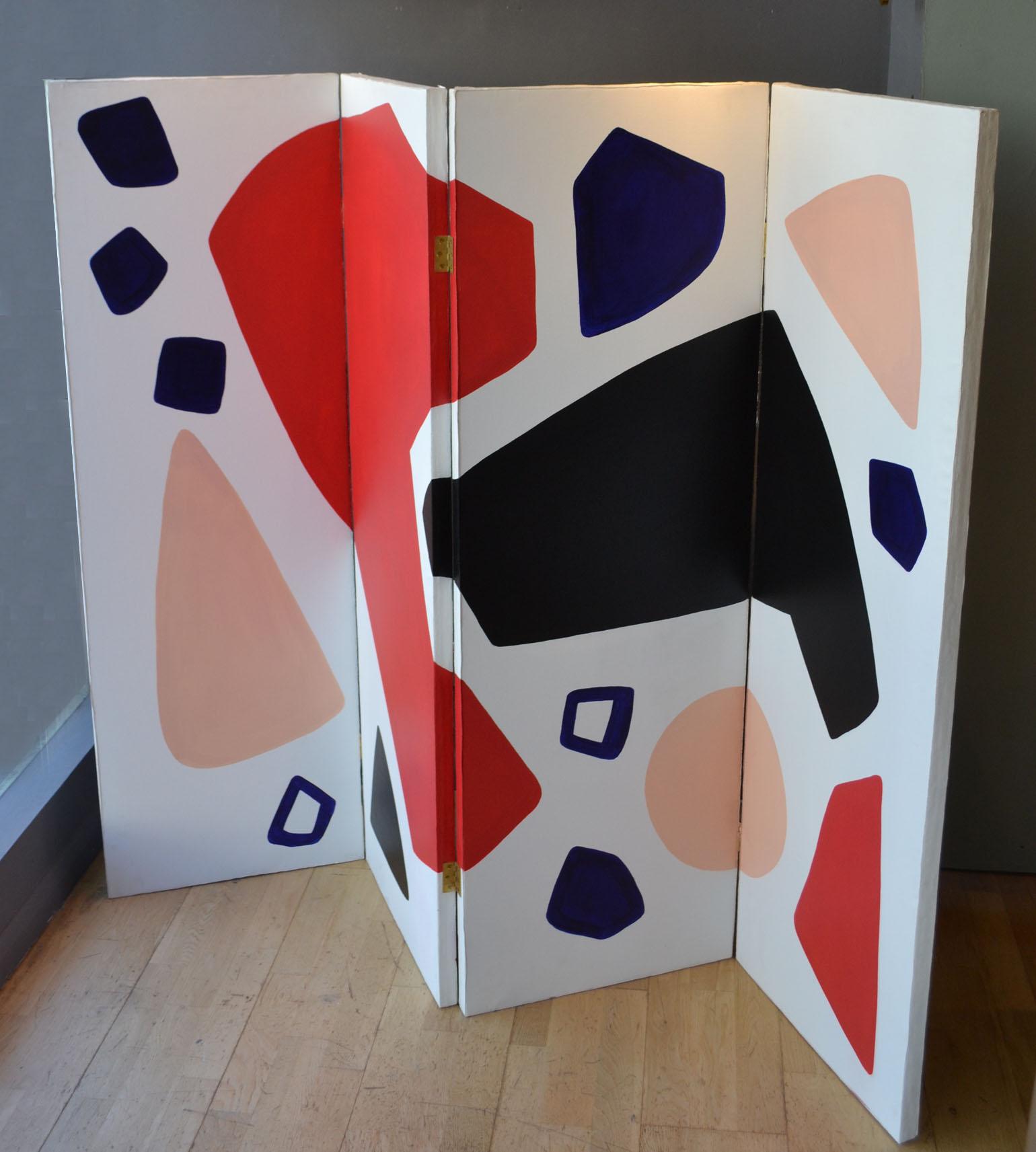 Two-sided room divider or folding screen hand painted on canvas stretched over a wooden frame with bold colors and shapes in black, blue, red and pink on a white background, by the contemporary French designer Alice Louradour.

 