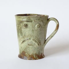 Expressive studio pottery mug, hand-thrown and sculpted with a stylized face