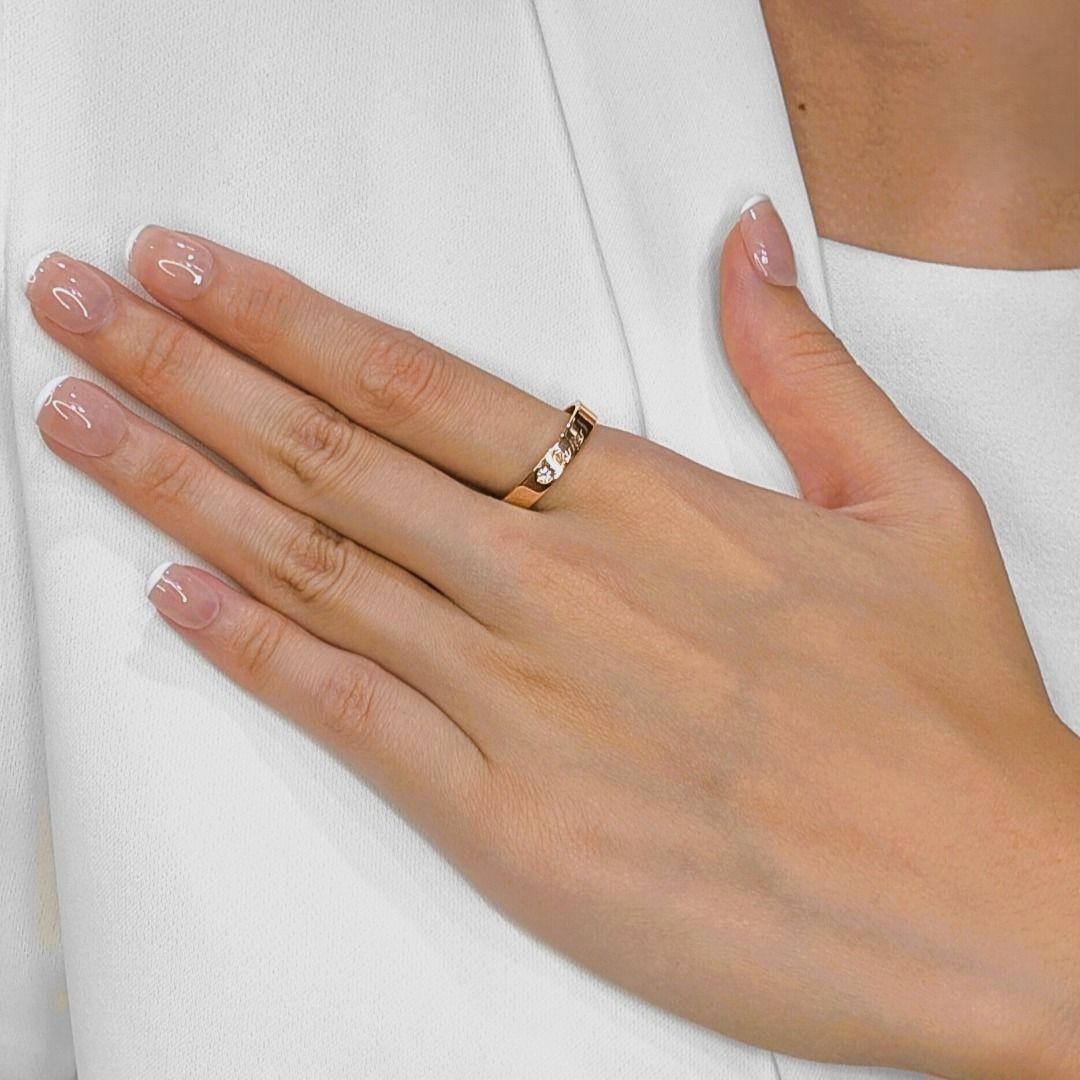 Crafted in luxurious 18K rose gold, this authentic Cartier band showcases timeless sophistication with a modern edge. The sleek design is elevated by a single natural round brilliant-cut diamond, weighing 0.03ct, set seamlessly into the band for a