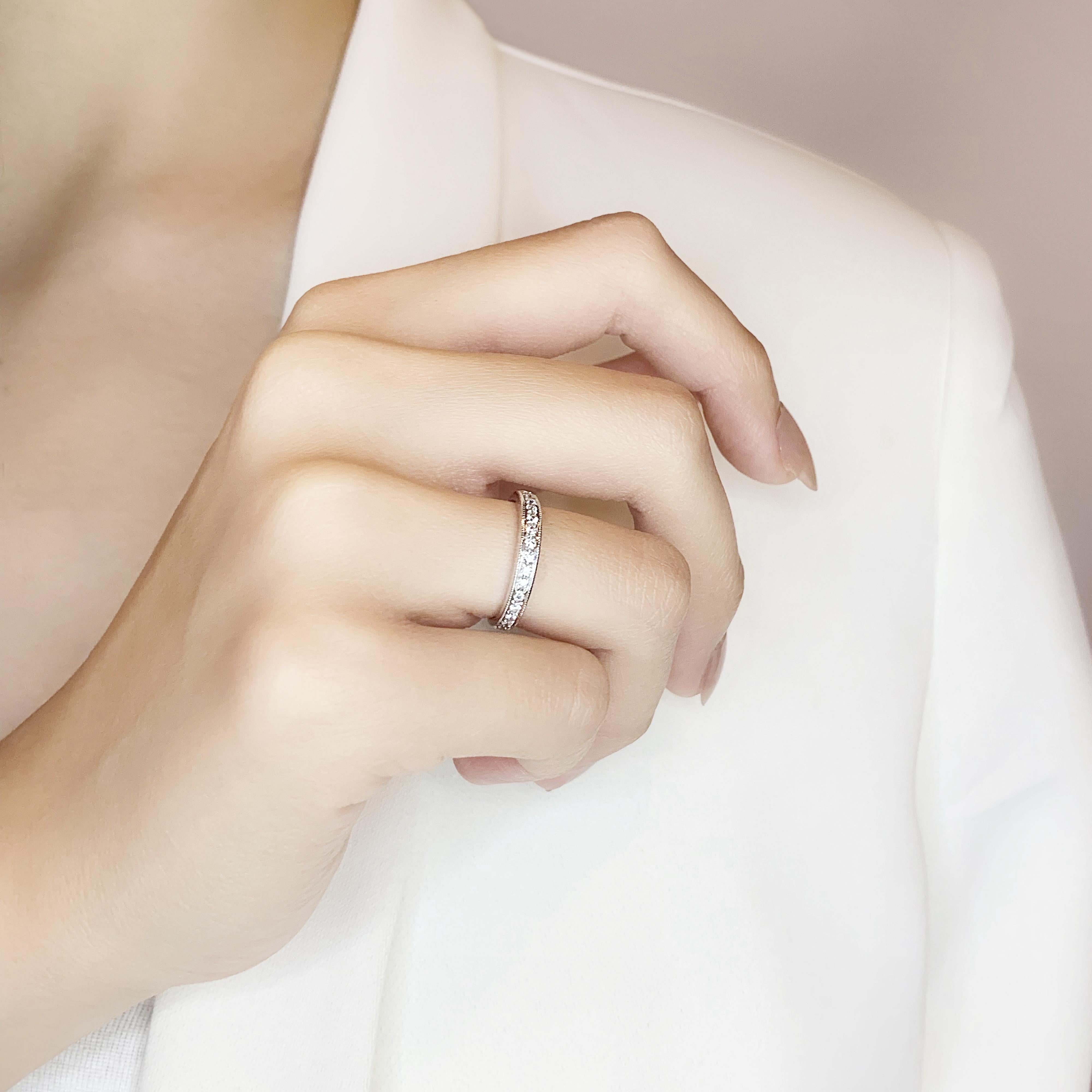 This stunning ring features 15 round brilliant diamonds, elegantly set in 18K white gold. The main stones, with a total carat weight of 0.12ct, showcase a G color grade and VS clarity grade, ensuring a brilliant sparkle. The ring, with a total