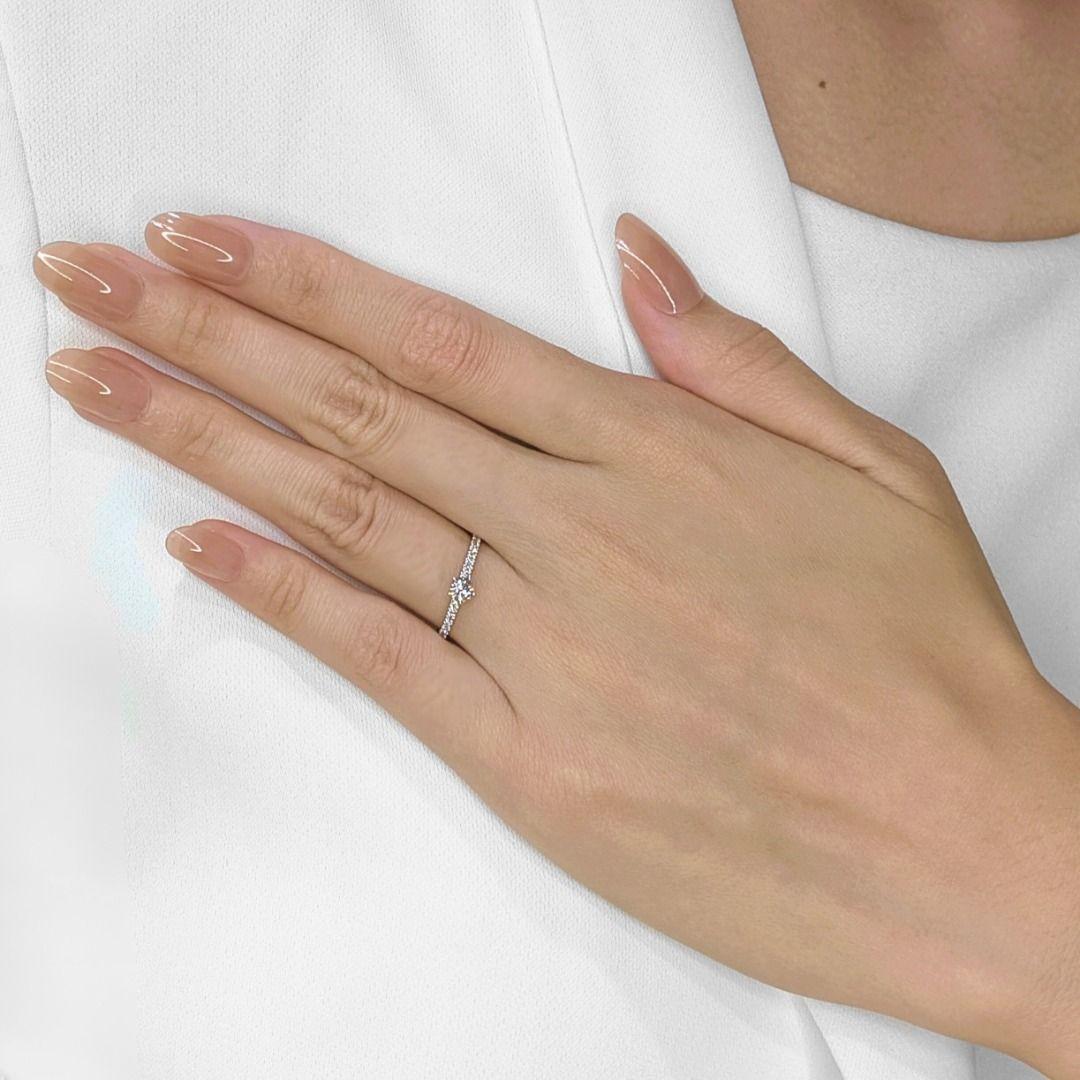 Elevate your collection with this pre-owned Gold Heart pave ring, designed to exude graceful brilliance in 14K white gold. At its heart, a 0.23-carat round brilliant natural diamond shimmers with a refined G-color and VS clarity, radiating pure