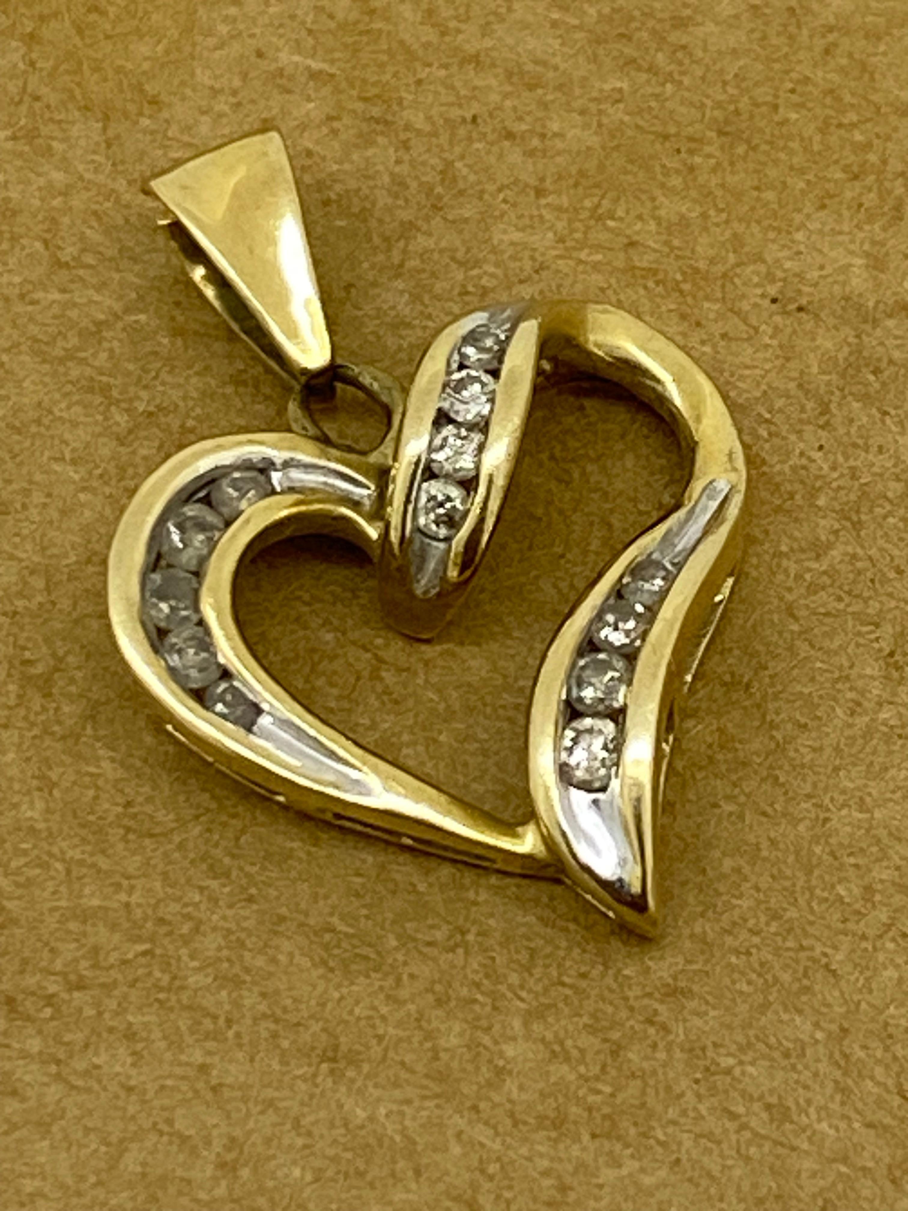 Embellished with Round Brilliant Cut Diamonds
lavishly channel-set throughout, 
Colour: G – H / SI
total approx. diamonds' weight: 0.35ct 

In a shape of open heart, 
the pendant is crafted in 9K White & Yellow Gold 
(stamped 375 on a bail)

The