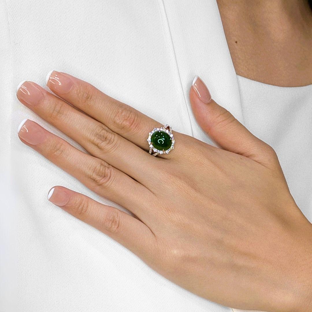 Discover unparalleled elegance with this exquisite ring, meticulously crafted in radiant 18K white gold and accompanied by a prestigious NGI certification. At its heart lies a magnificent oval cabochon jade, measuring an impressive 12MM in length by