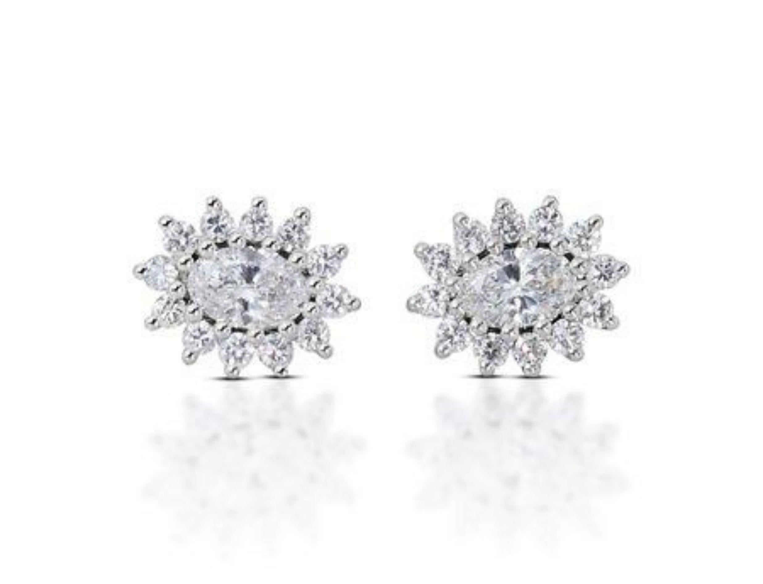 Exquisite 0.6 Carat Oval Brilliant Diamond Earrings with 0.41 Carat Side Diamonds in 14K White Gold (AIG Certified). These captivating earrings showcase two stunning 0.6 carat oval brilliant natural diamonds, certified by AIG J3312264425. The