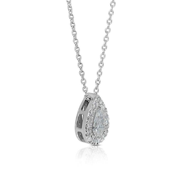 Embrace timeless elegance with this captivating necklace, showcasing a mesmerizing 0.7 carat pear brilliant diamond, boasting exceptional brilliance and fire. The dazzling center stone, meticulously cut for optimal light performance, takes center