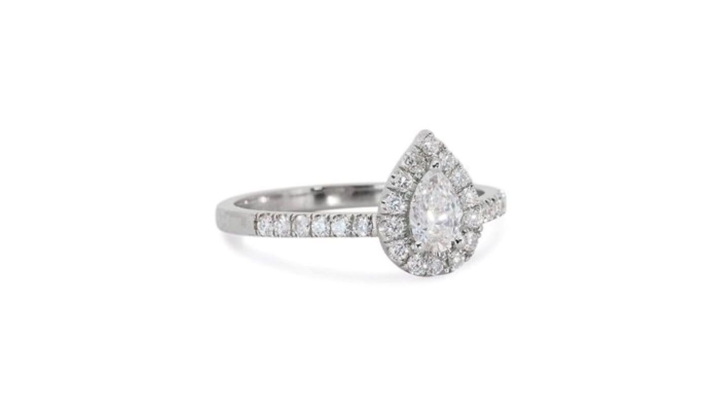 Embrace timeless elegance with this captivating ring, featuring a mesmerizing 0.7 carat pear brilliant diamond, radiating brilliance and fire. The captivating center stone, meticulously cut for exceptional light performance, takes center stage.