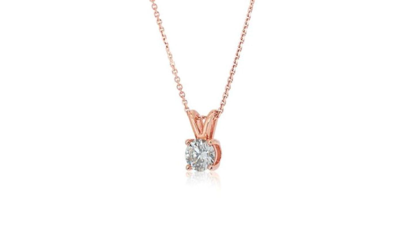 Embrace timeless elegance with this captivating necklace, showcasing a mesmerizing 0.7 carat round brilliant diamond. The meticulously cut center stone, boasting exceptional brilliance and fire, takes center stage. Crafted in luxurious 18K rose gold