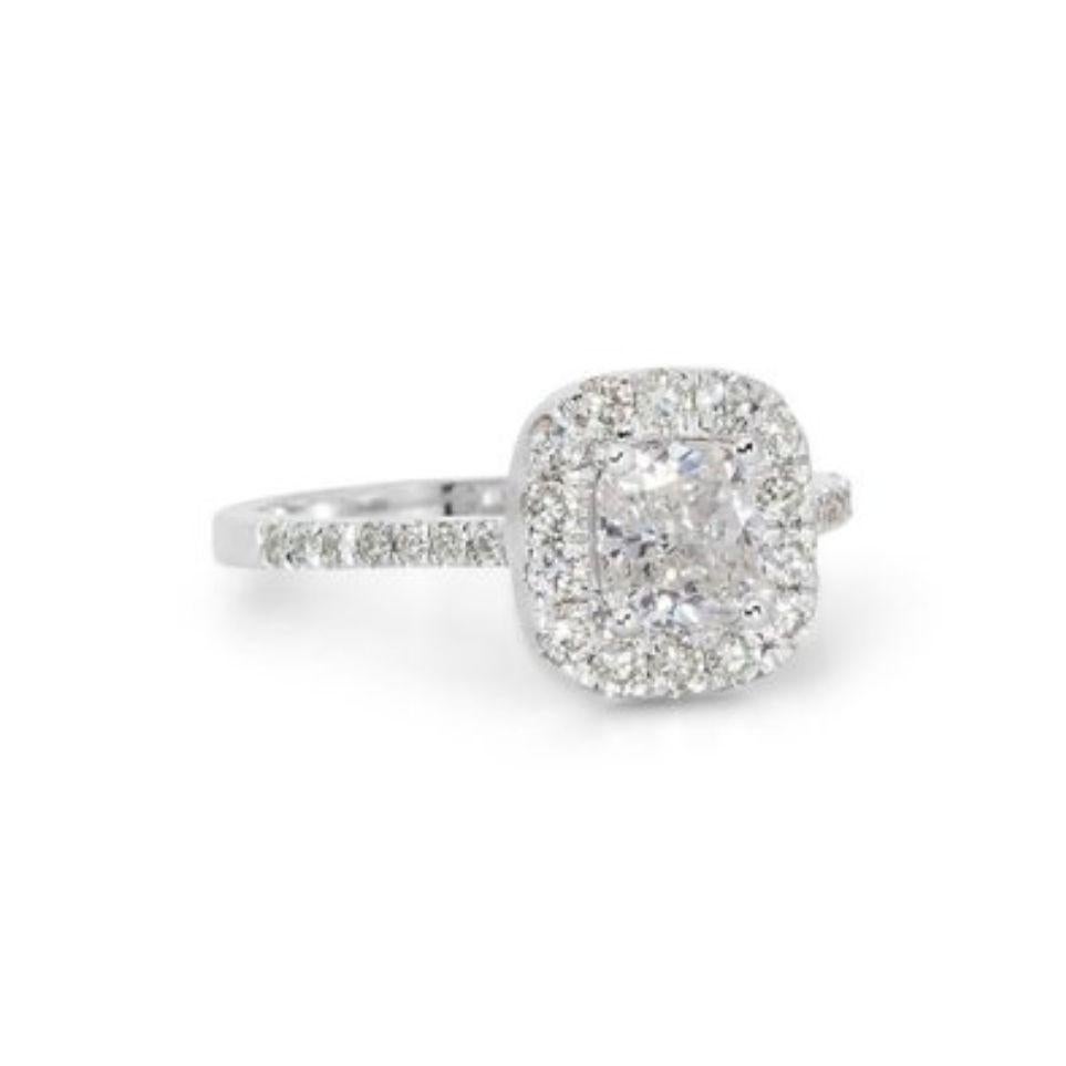 Embrace sophisticated sparkle with this captivating ring, showcasing a dazzling 0.9 carat cushion diamond, meticulously set in gleaming 18K white gold. The exceptional D color (highest color grade!) ensures remarkable brilliance, while the SI1