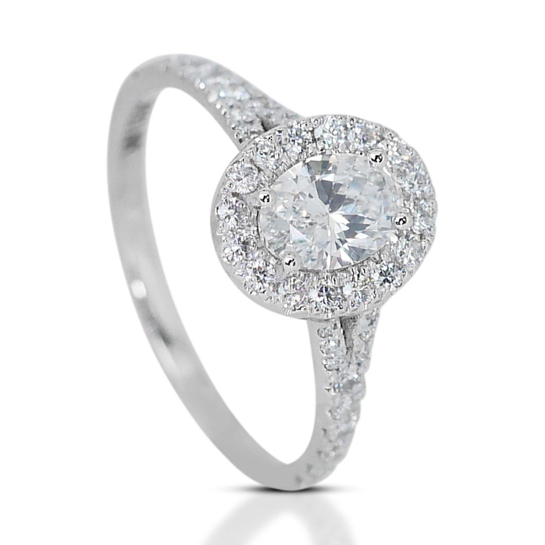 Exquisite 1.04ct Oval Diamond Halo Ring in 18k White Gold - GIA Certified

Experience the allure of refined luxury with this exquisite 18k white gold diamond ring, featuring a central oval-shaped diamond that weighs 1.00-carat. Accompanying the