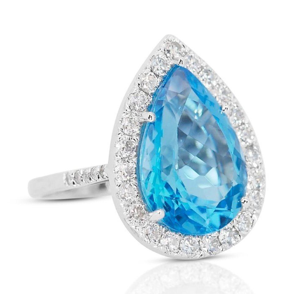 Surrounding the striking topaz are thirty-three round brilliant-cut diamond side stones, totaling 1.04 carats. Graded G-H in color and VS2-SI1 in clarity, these diamonds radiate brilliance and sparkle, beautifully accentuating the vibrant topaz