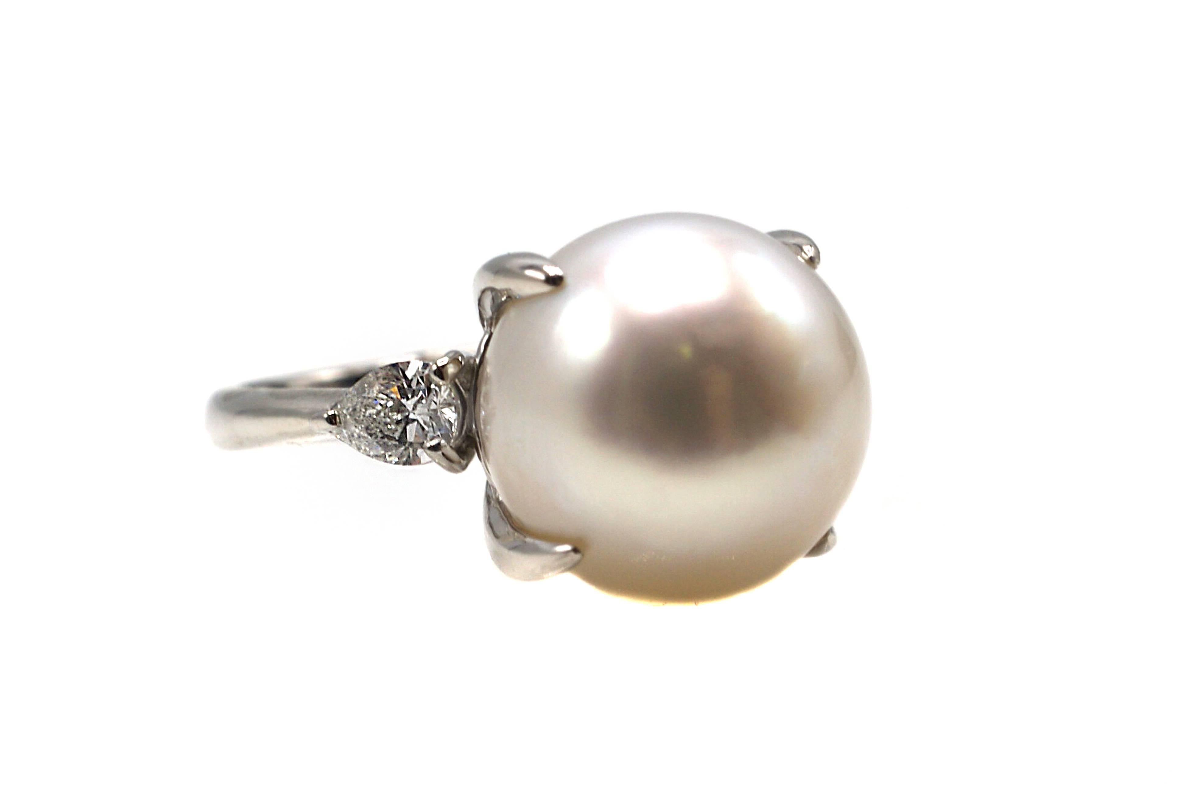 This ring features a centrally set exquisite 12 millimeter bright white and lustrous South Sea pearl set in a handcrafted platinum mounting.Only many years of culturing this pearl in the oyster gives it the thick nacre to make it this shiny and
