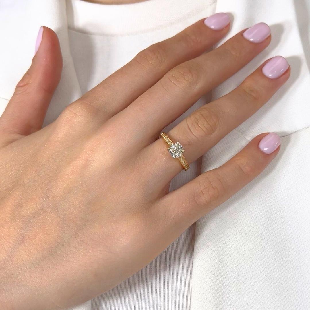 Squisito anello con pavé di diamanti da 1,25 carati in oro giallo e bianco 18 carati - certificato IGI

Grazioso e pieno di calore dorato, questo anello con pavé in oro giallo e bianco 18 carati presenta al centro un diamante con taglio a cuscino da